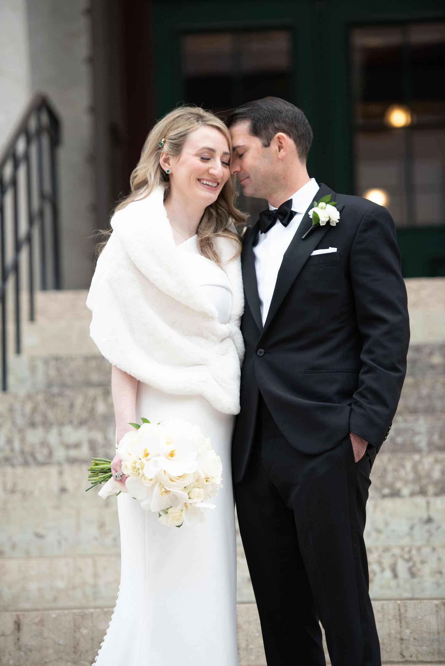 Elegant couple sharing an intimate moment on stone steps.
