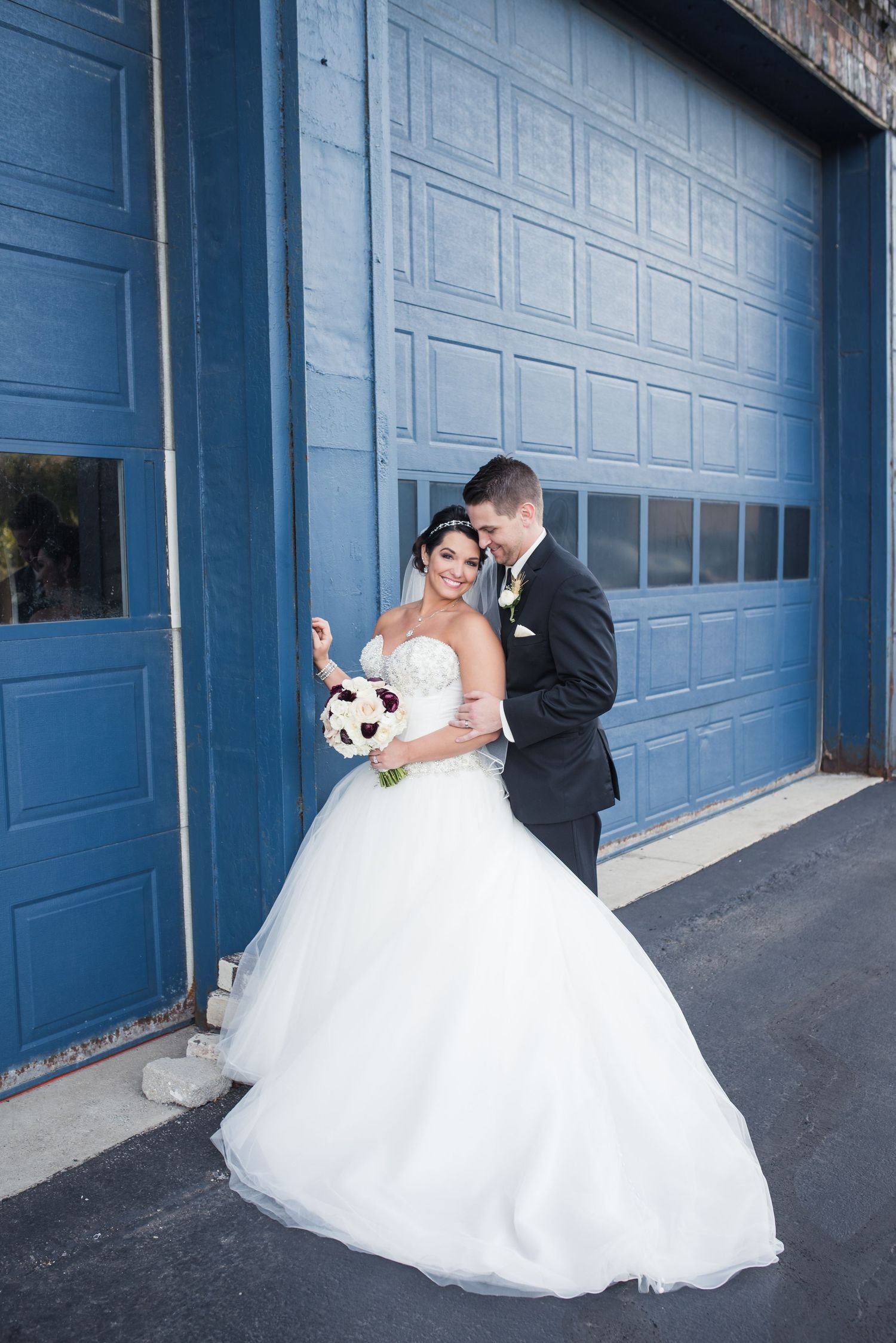 A series of romantic wedding photos showing a couple in formal attire against blue garage doors.