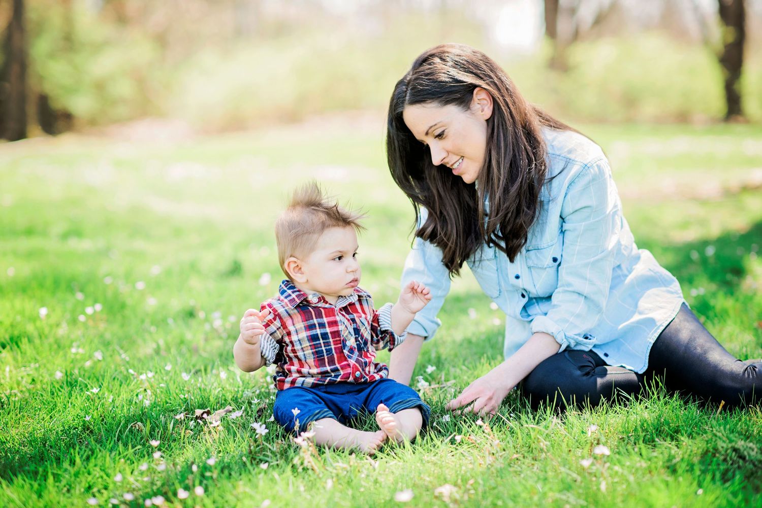 Family enjoying a sunny spring day together in a green park setting with candid outdoor moments.