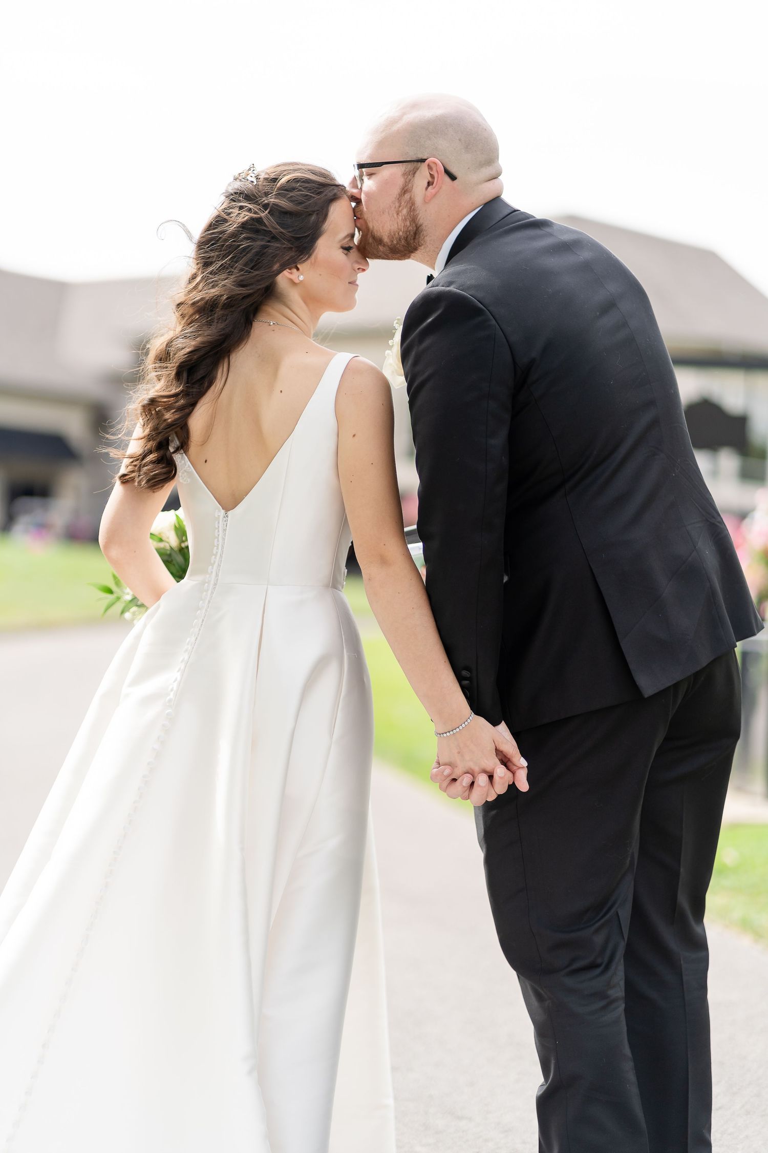 Romantic wedding couple sharing intimate kisses in a series of black and white portraits.