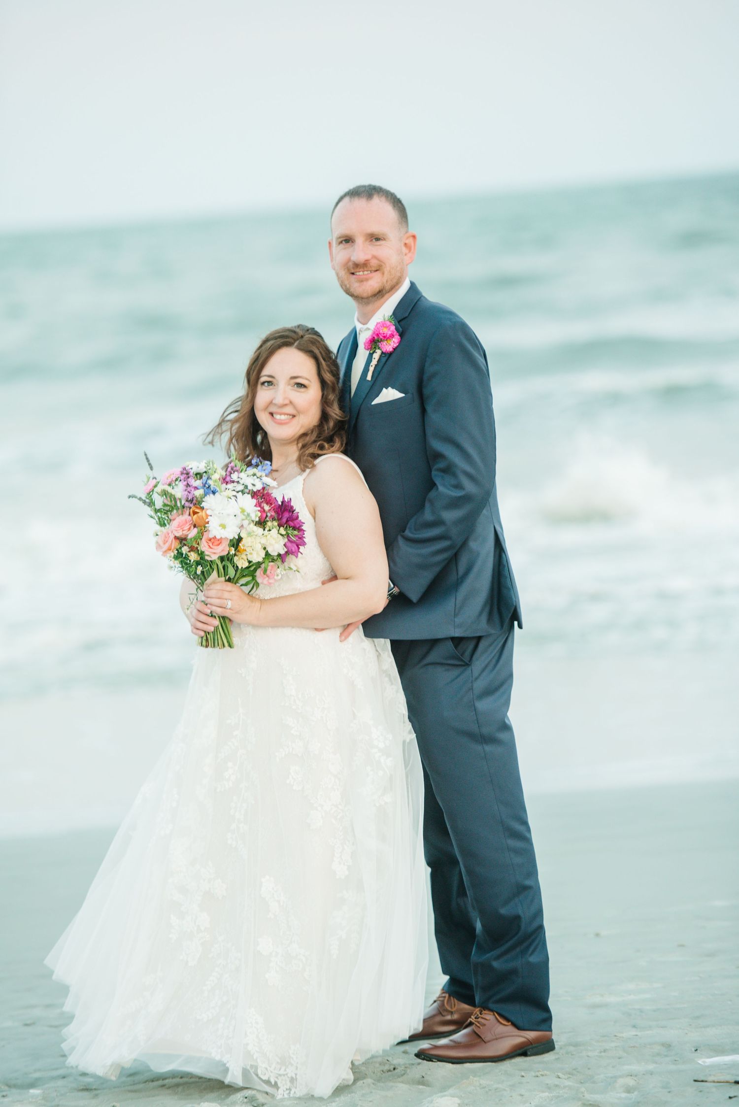 Beachside wedding portraits with waves and ocean creating a romantic coastal backdrop. Hilton Head