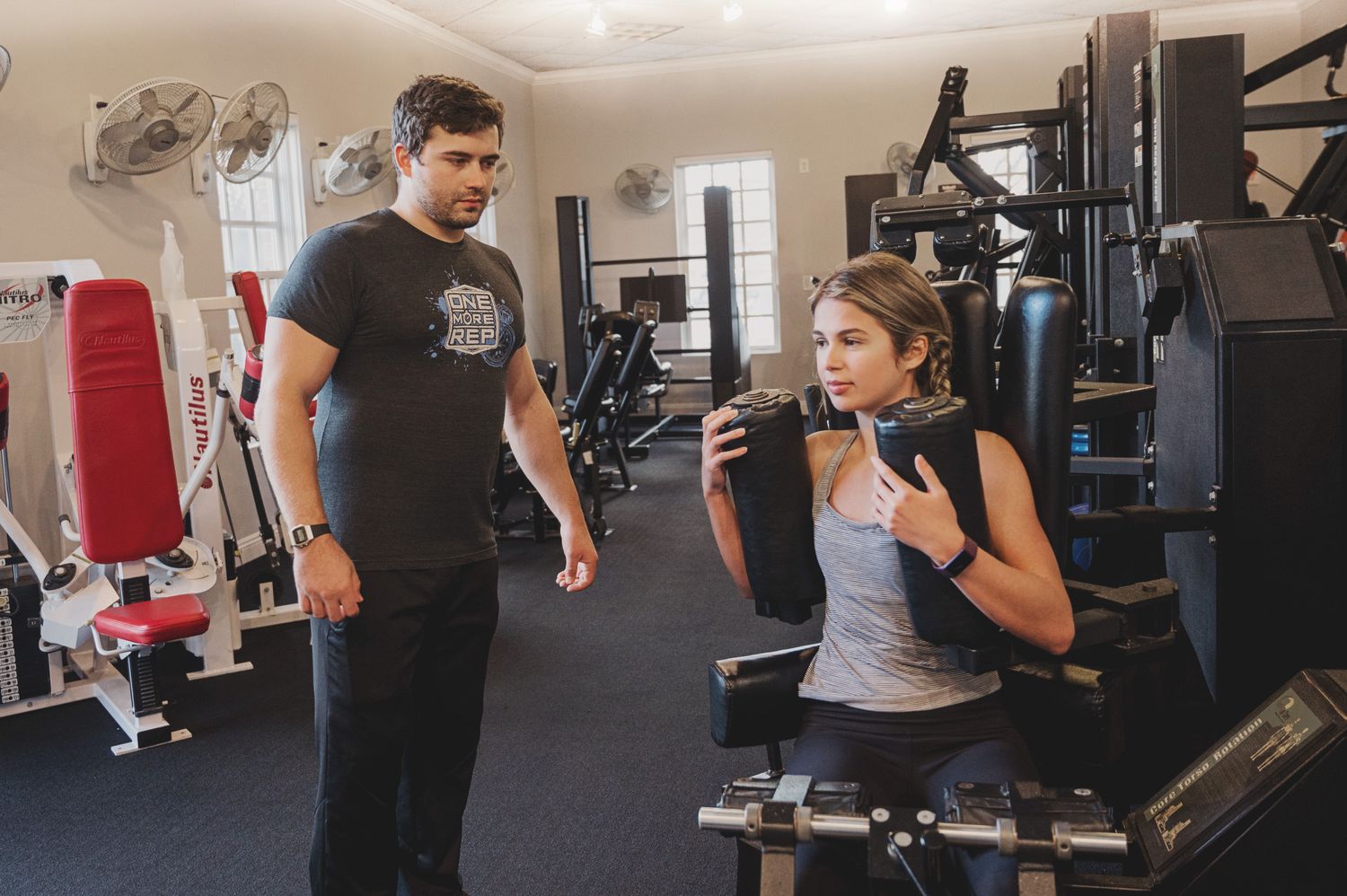 Group workout session in a modern gym with exercise equipment.