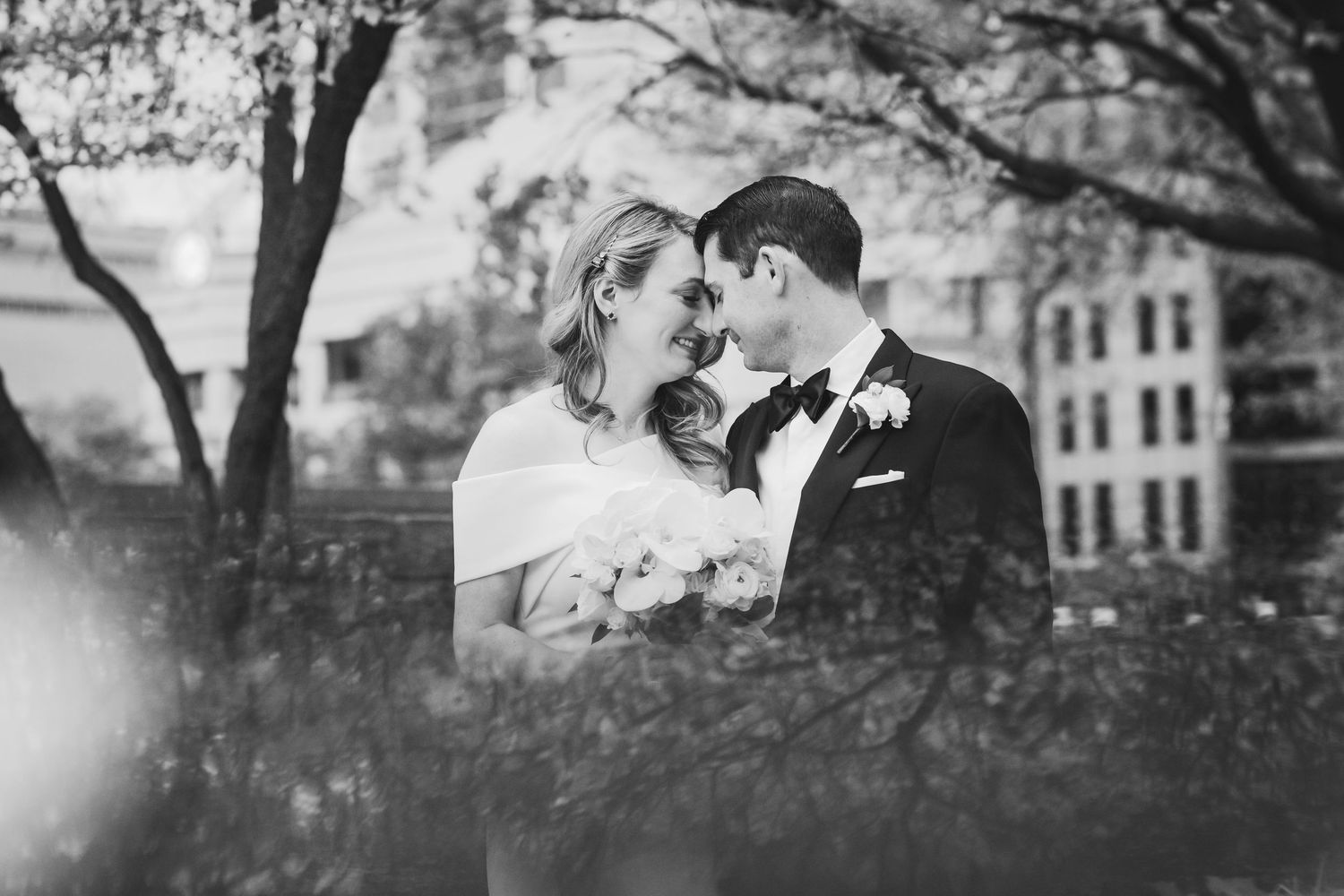 Artistic black and white silhouette of trees and buildings creating a romantic wedding backdrop.