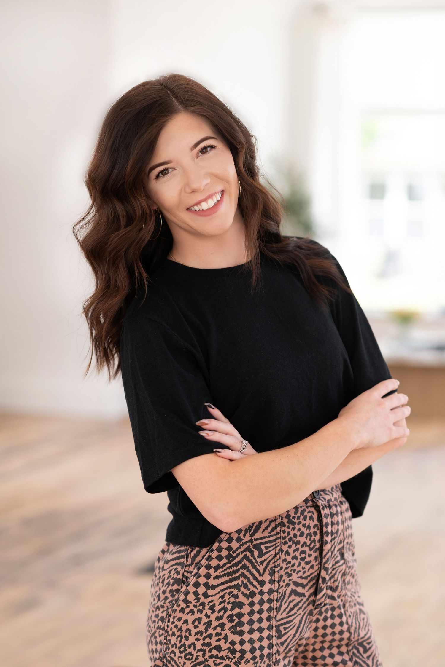 Studio portraits featuring black top and animal print skirt with natural poses.