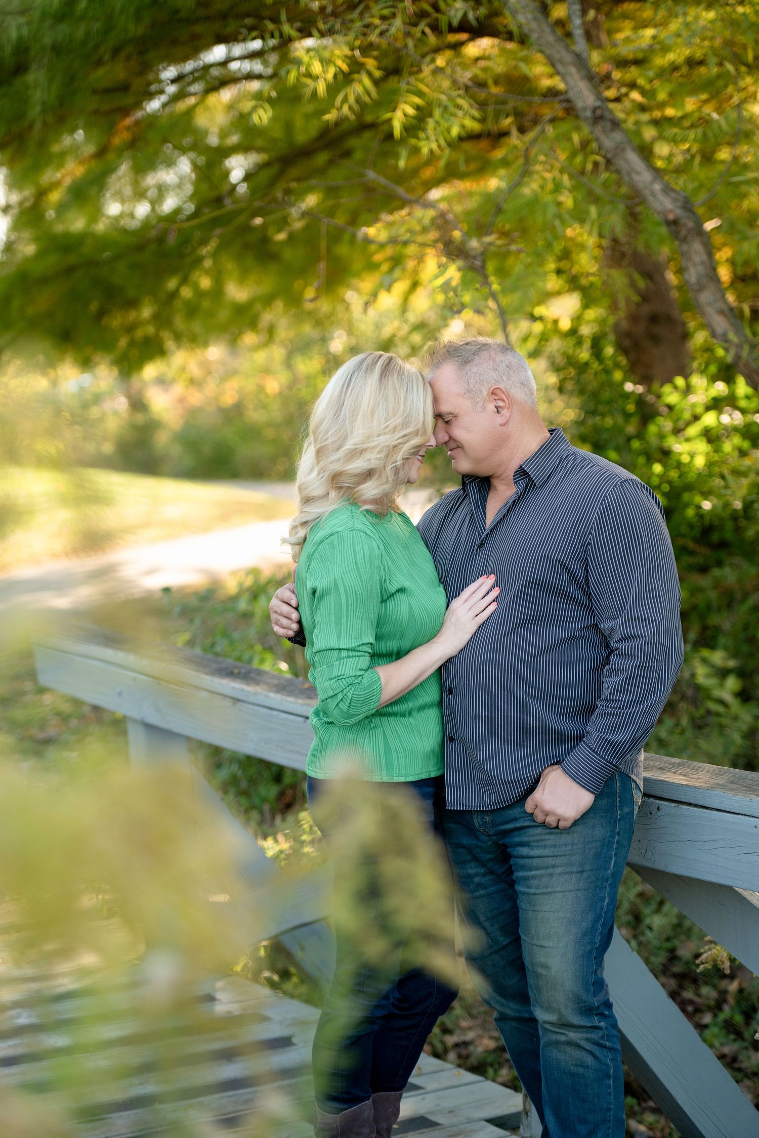 Sweet couple moments captured in sequence against a natural fall backdrop with wooden fence.