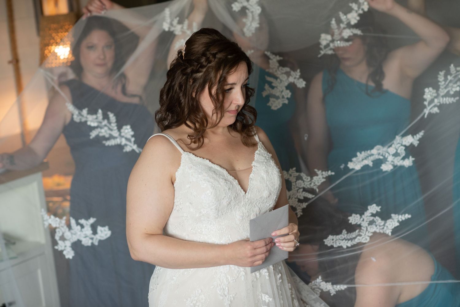 Wedding preparation scene with white lace dress details and soft lighting.