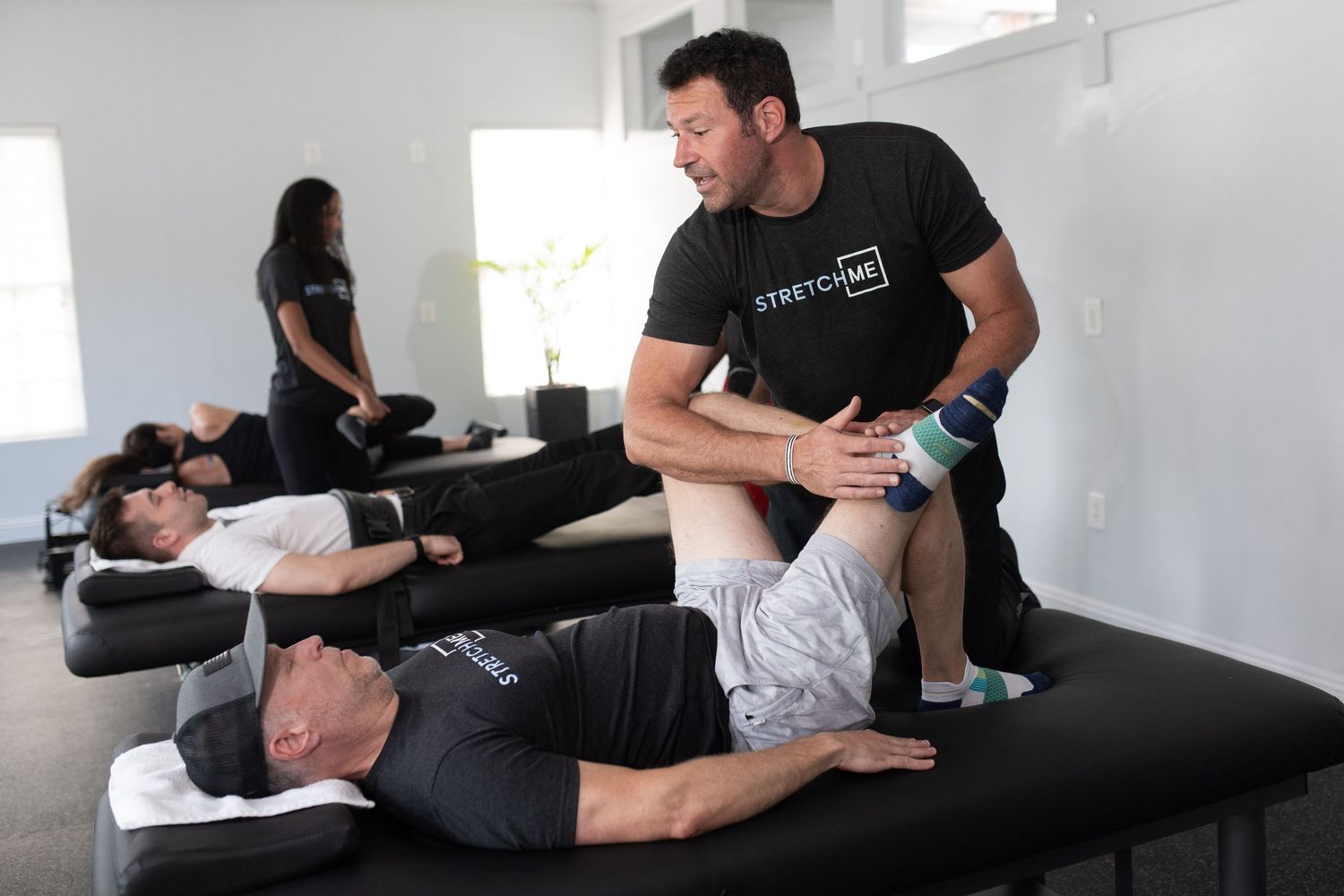 Healthcare professional demonstrating therapeutic techniques in a medical setting.