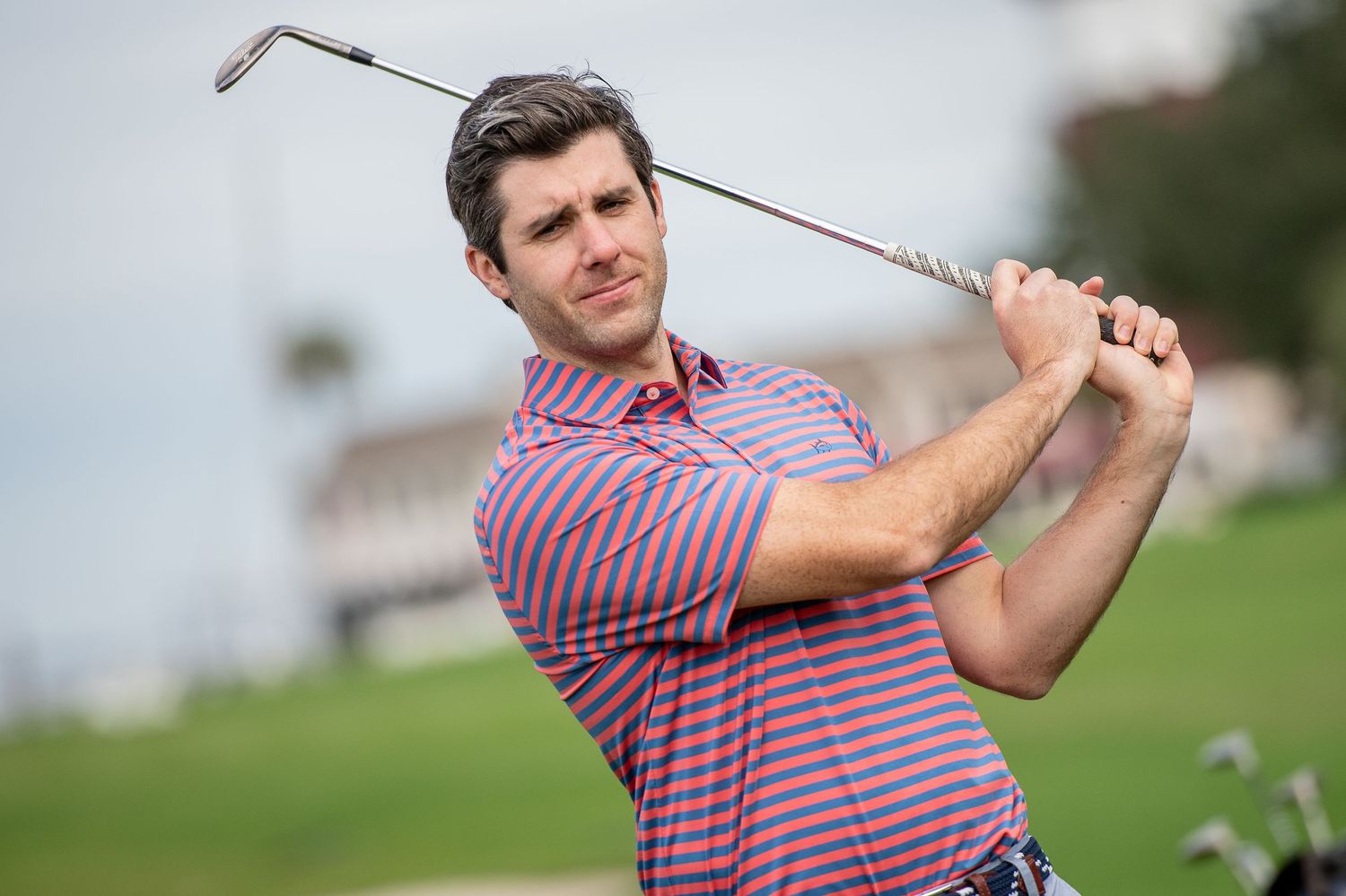 Golfer in striped shirt demonstrates golf swing form. Sea Pines Hilton Head