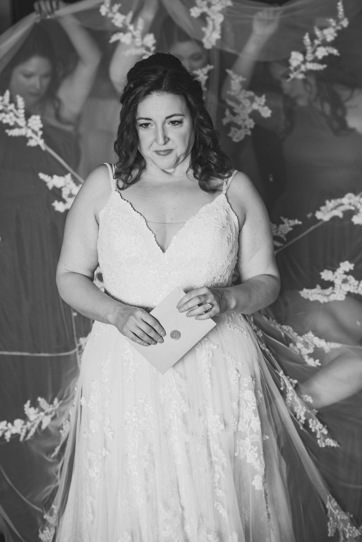 Elegant white lace wedding dress with delicate floral details in black and white.