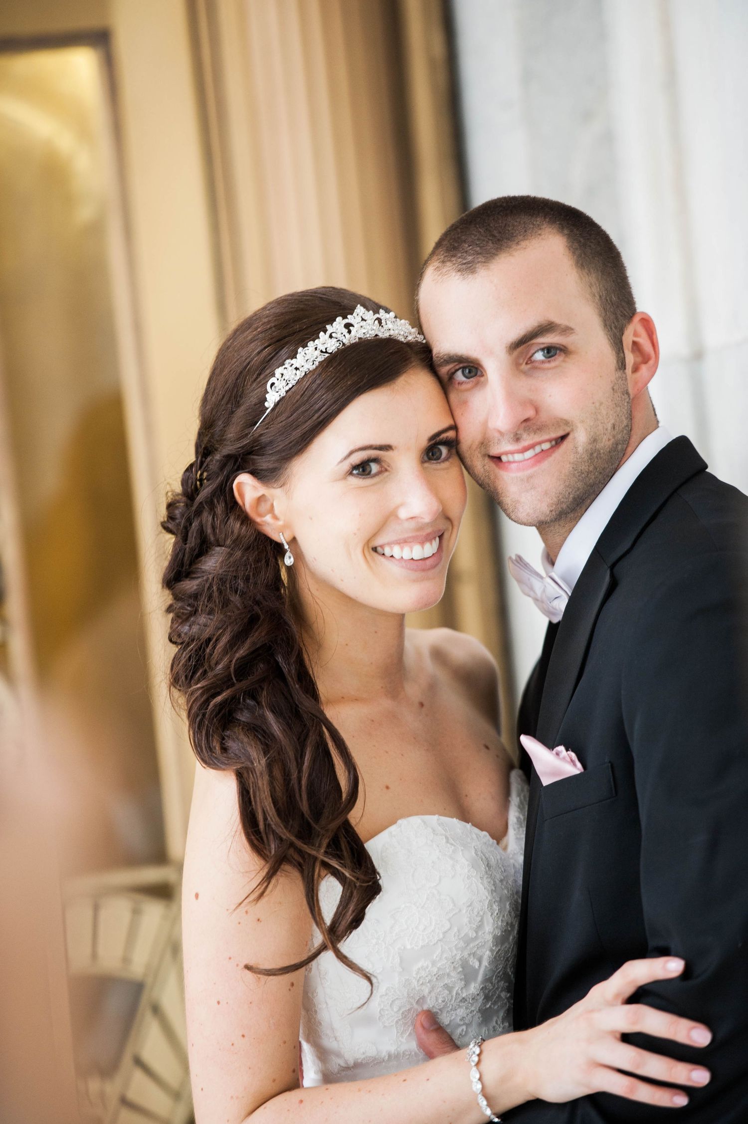 Elegant bride and groom share intimate moments in formal indoor portraits with soft lighting.