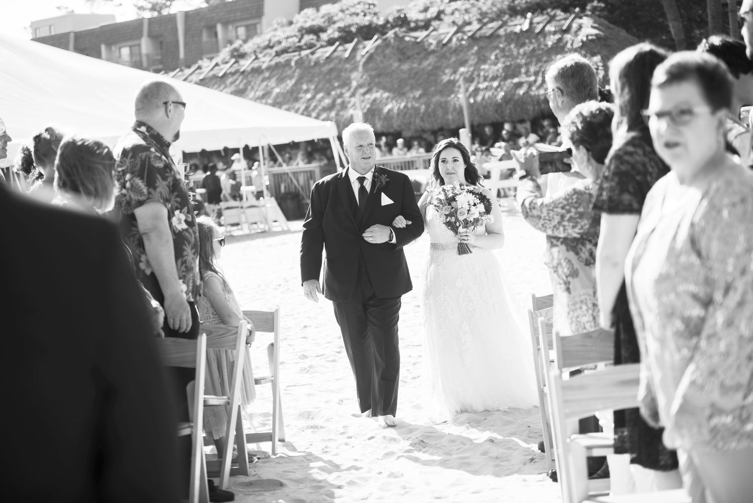 Black and white photo of wedding ceremony under tent on beach. Beach House Hilton Head