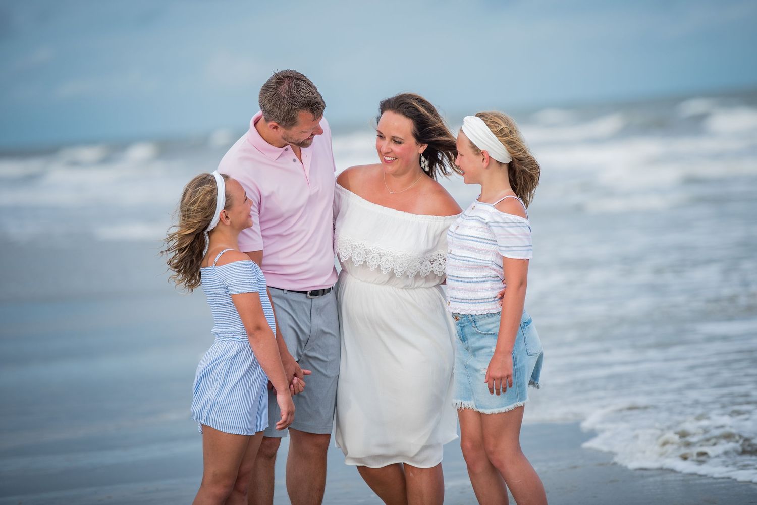 Family members walk along ocean shoreline at sunset. St. St. Augustine Beach, Hammock Beach photographer.