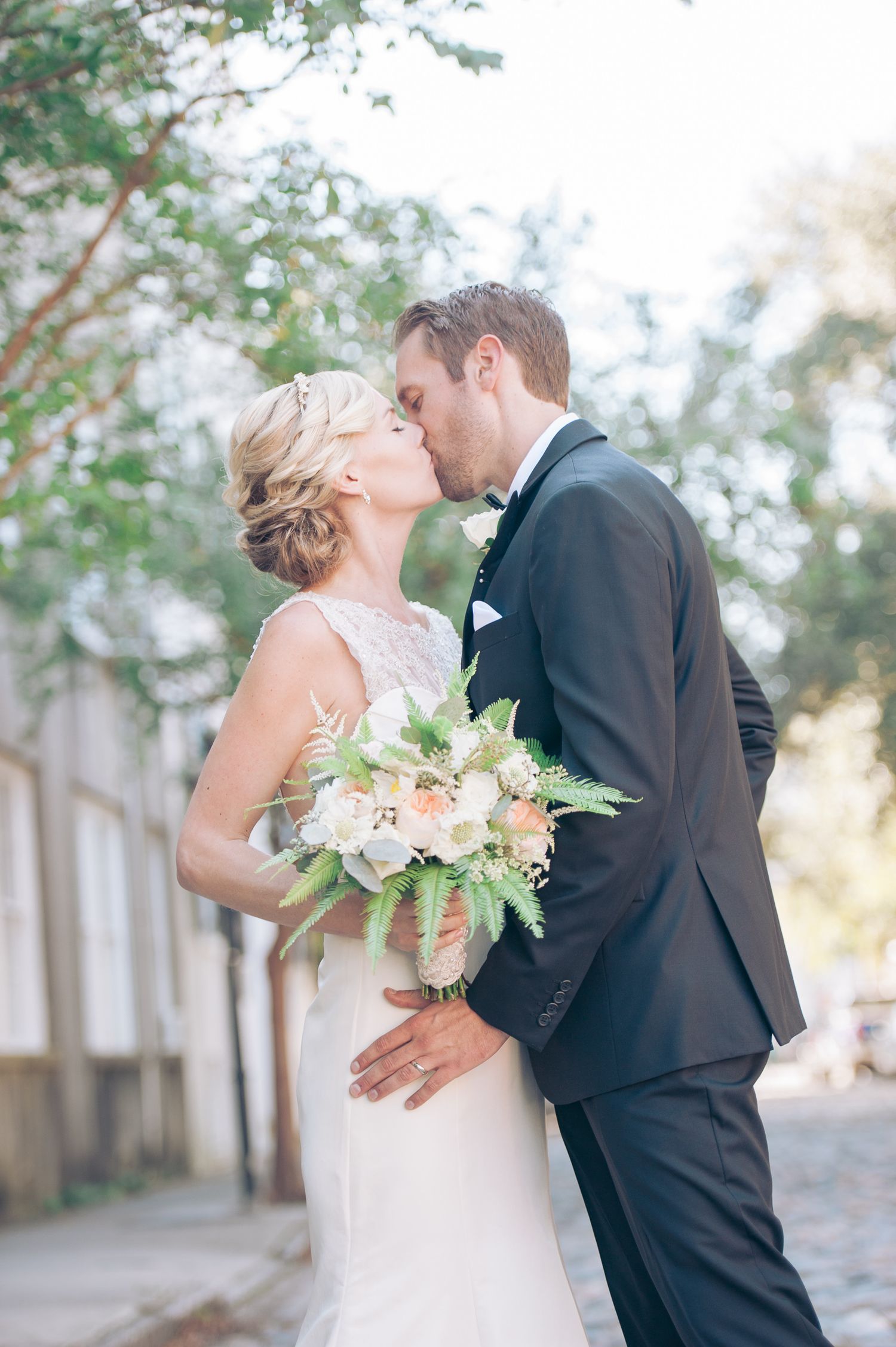 Intimate wedding moment captured in outdoor garden setting. St. Augustine wedding photographer.