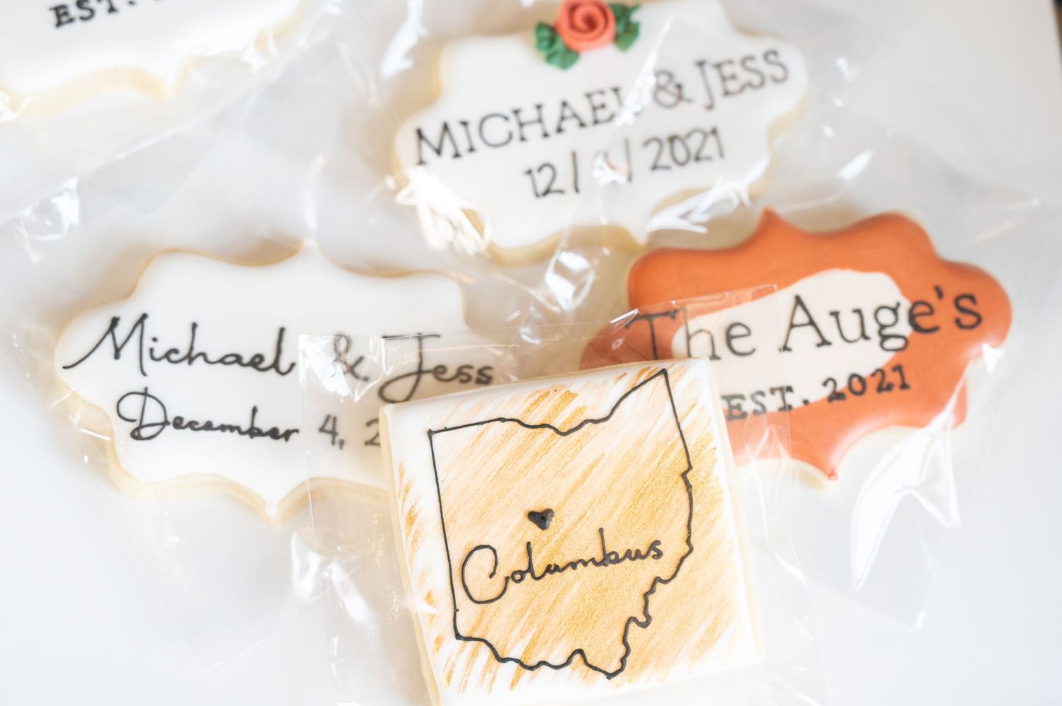 Wedding details with handwritten names and dates alongside a cutout of Ohio state shape on vintage paper elements.