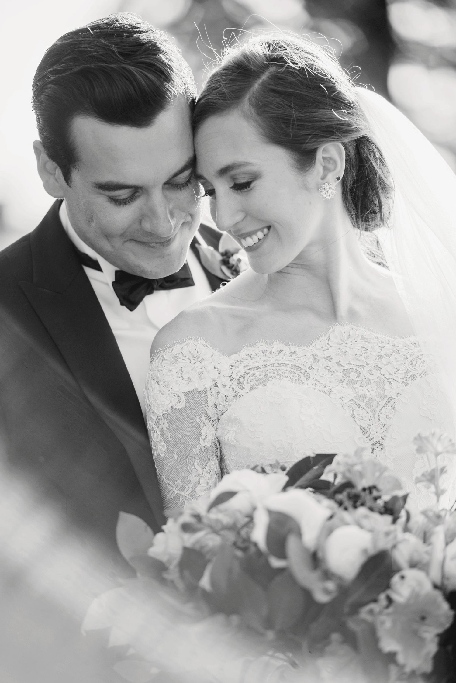 Black and white wedding photo series showing intimate moments between newlyweds with a bridal bouquet.