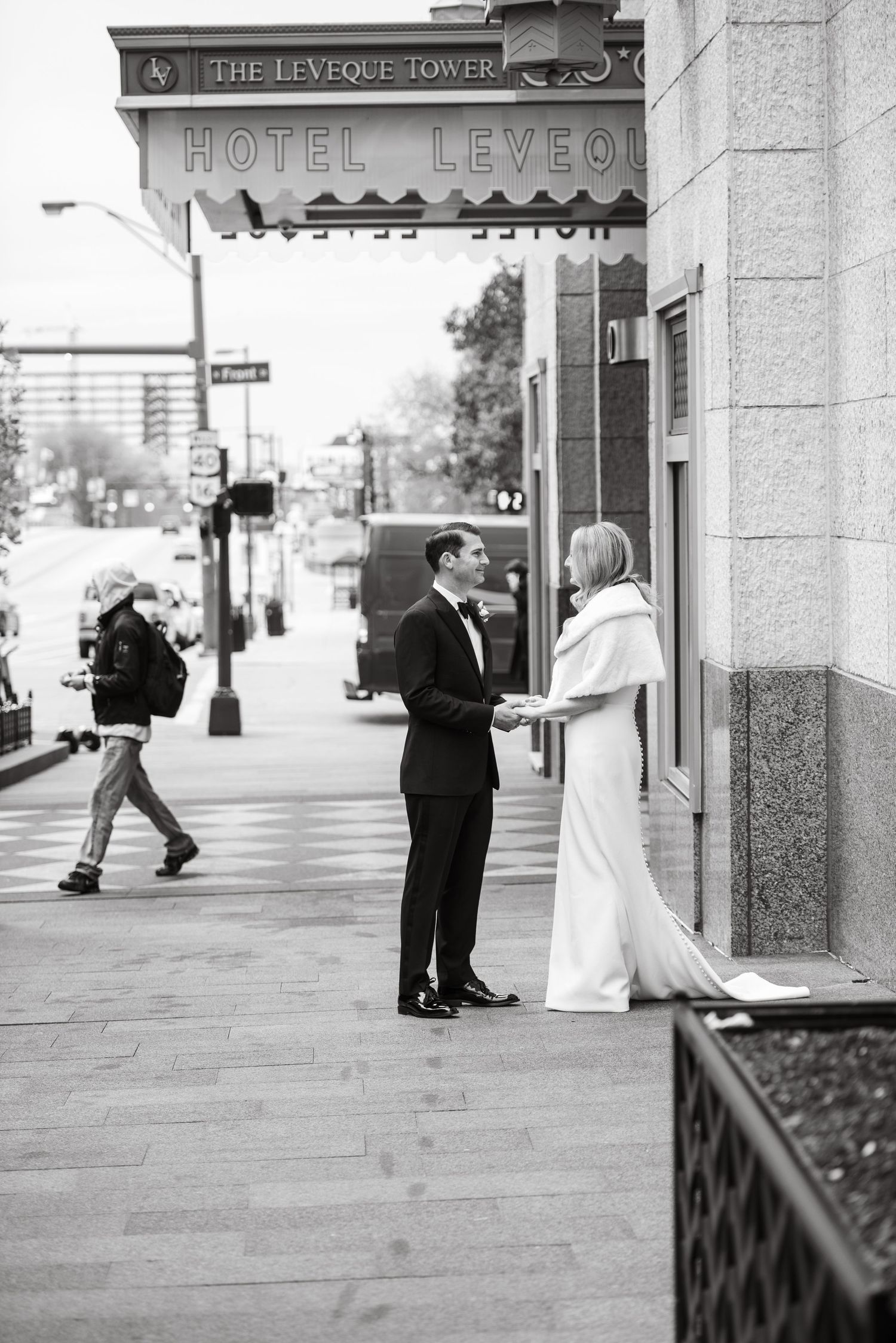 Black and white photo of couple outside Hotel Leveque.