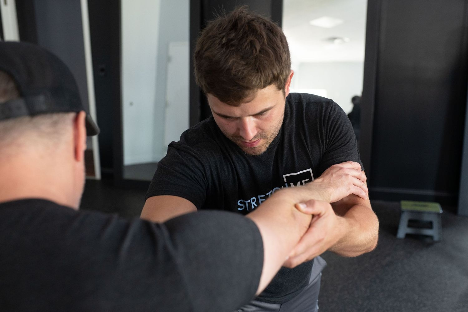 Professional therapist performing neck adjustment treatment in medical office.