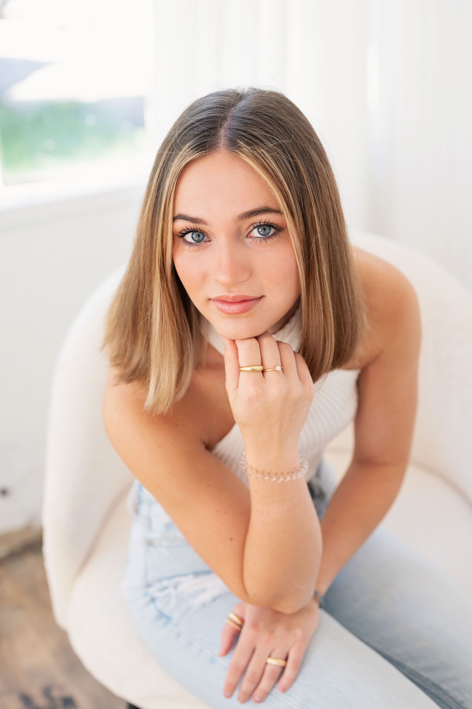 Bright studio portraits with soft lighting and casual styling.