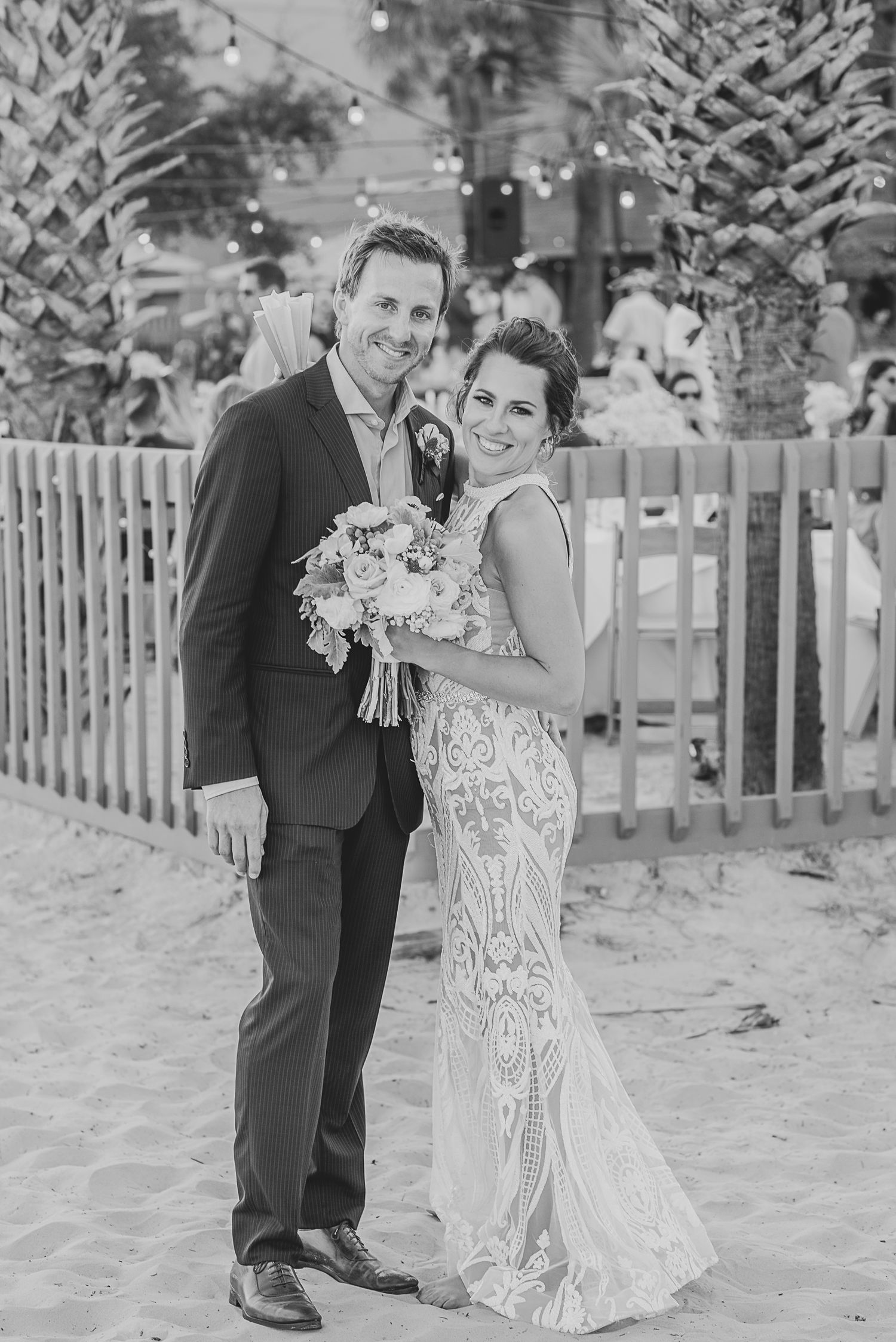 Black and white beach wedding photos showing couple posing together on sandy shore. St. Augustine Beach, Hammock Beach photographer.