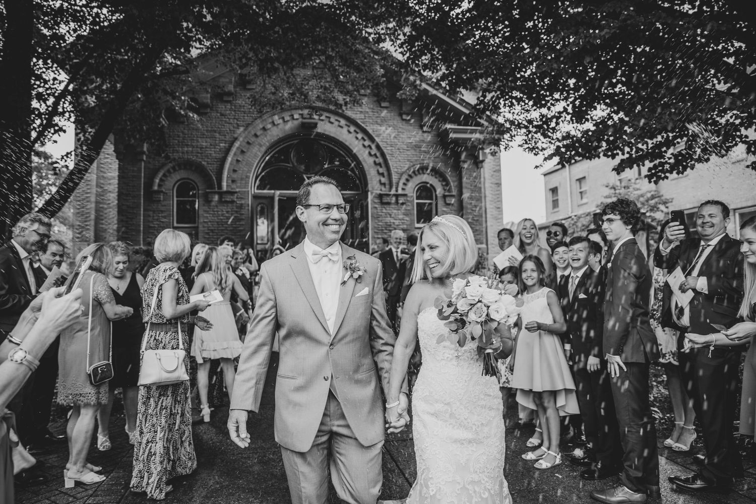 Large group gathered outside a historic stone building for a formal event. St. Augustine Wedding Photographer
