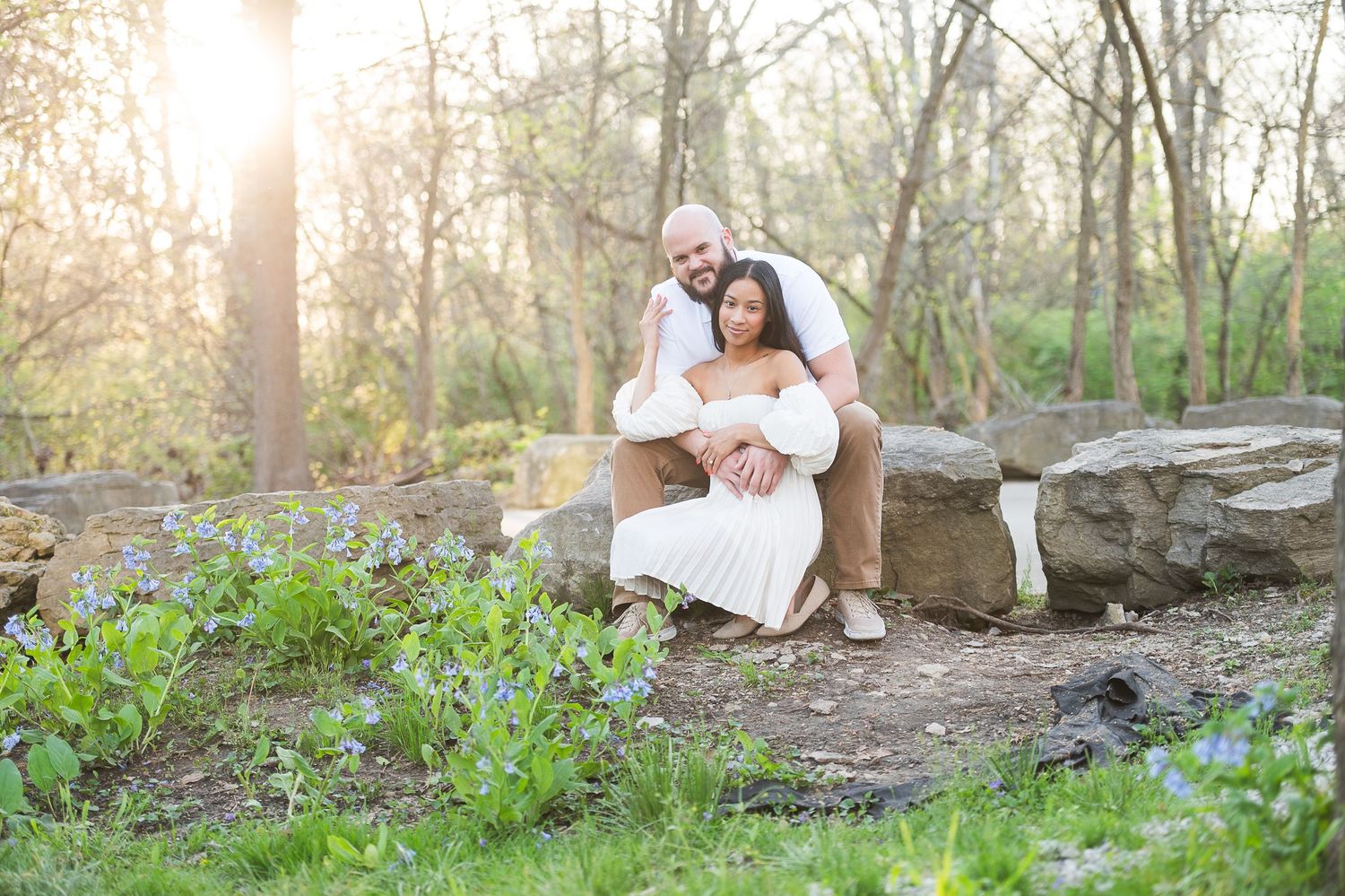 Couple shares tender moments on a wooden bridge during golden hour in a natural setting. Hammock Beach engagement session.