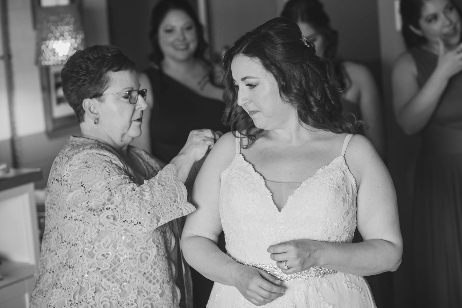 Intimate getting ready moments captured in black and white photography.