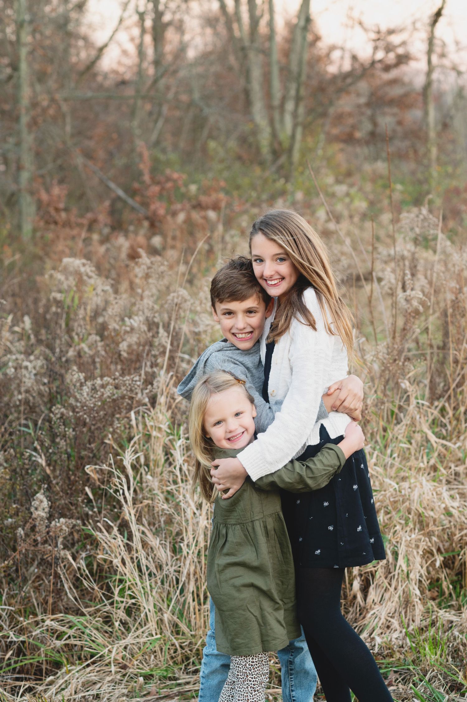 Playful family photo session in tall grass during autumn. Hammock Beach engagement session.