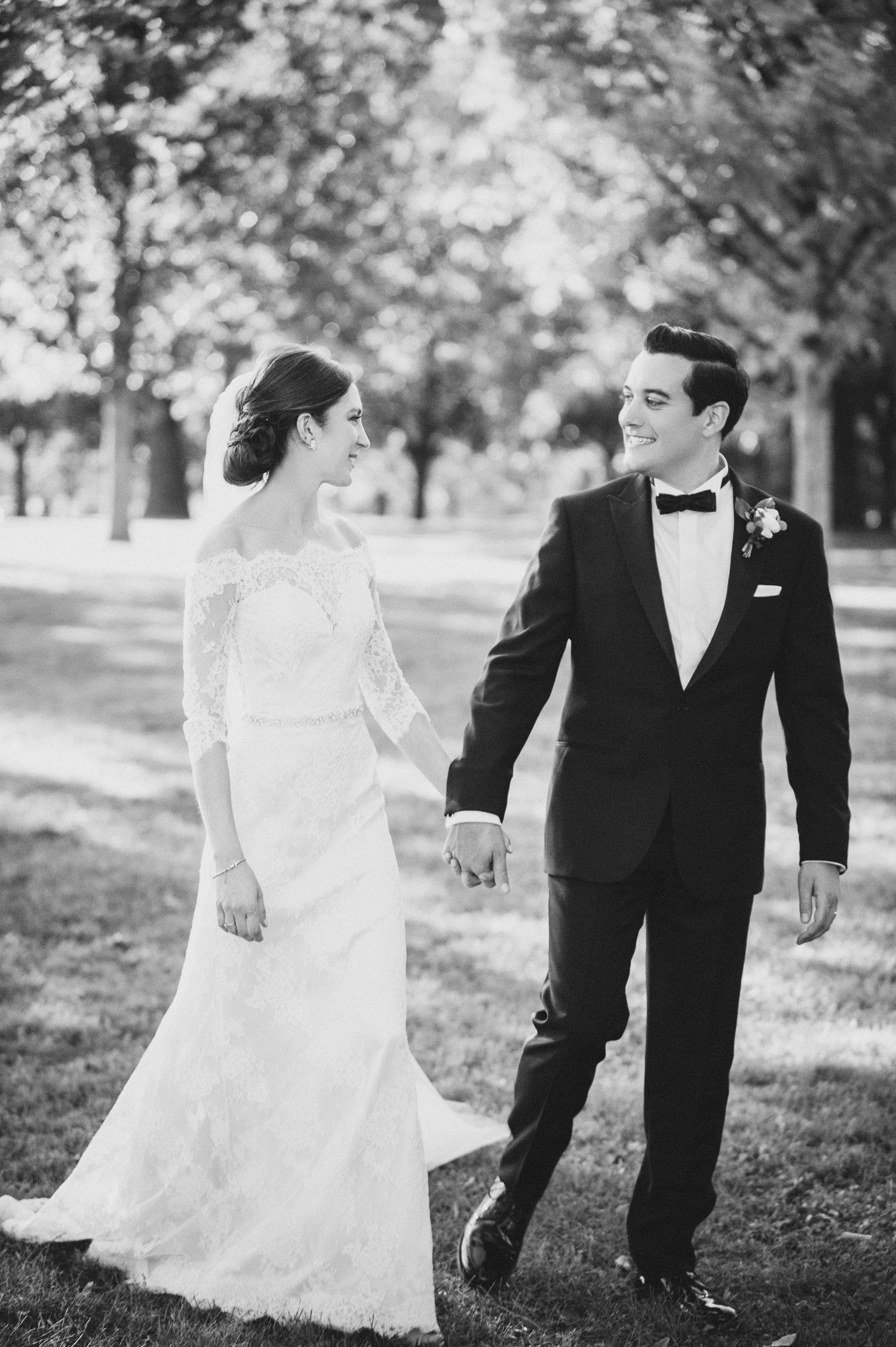 Black and white wedding photos showing a couple in formal attire walking and posing together in a park setting.