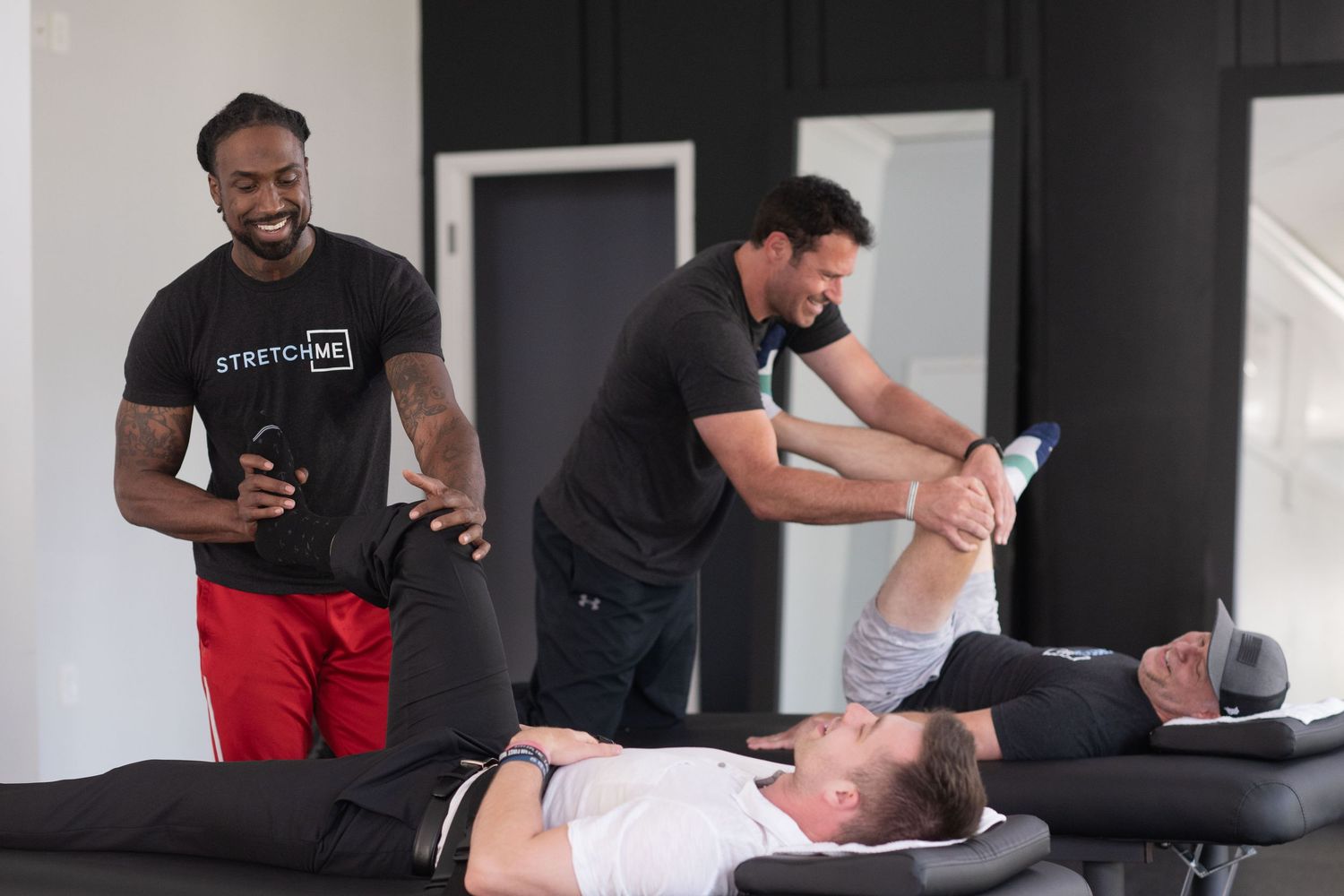 Medical practitioner providing physical therapy treatment in a clinical environment.