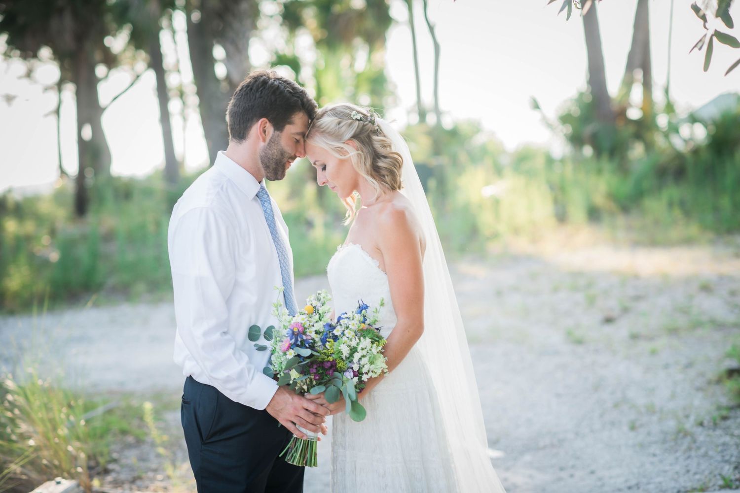 Romantic couple walking together on a sandy beach path during sunset. Hilton Head Wedding.