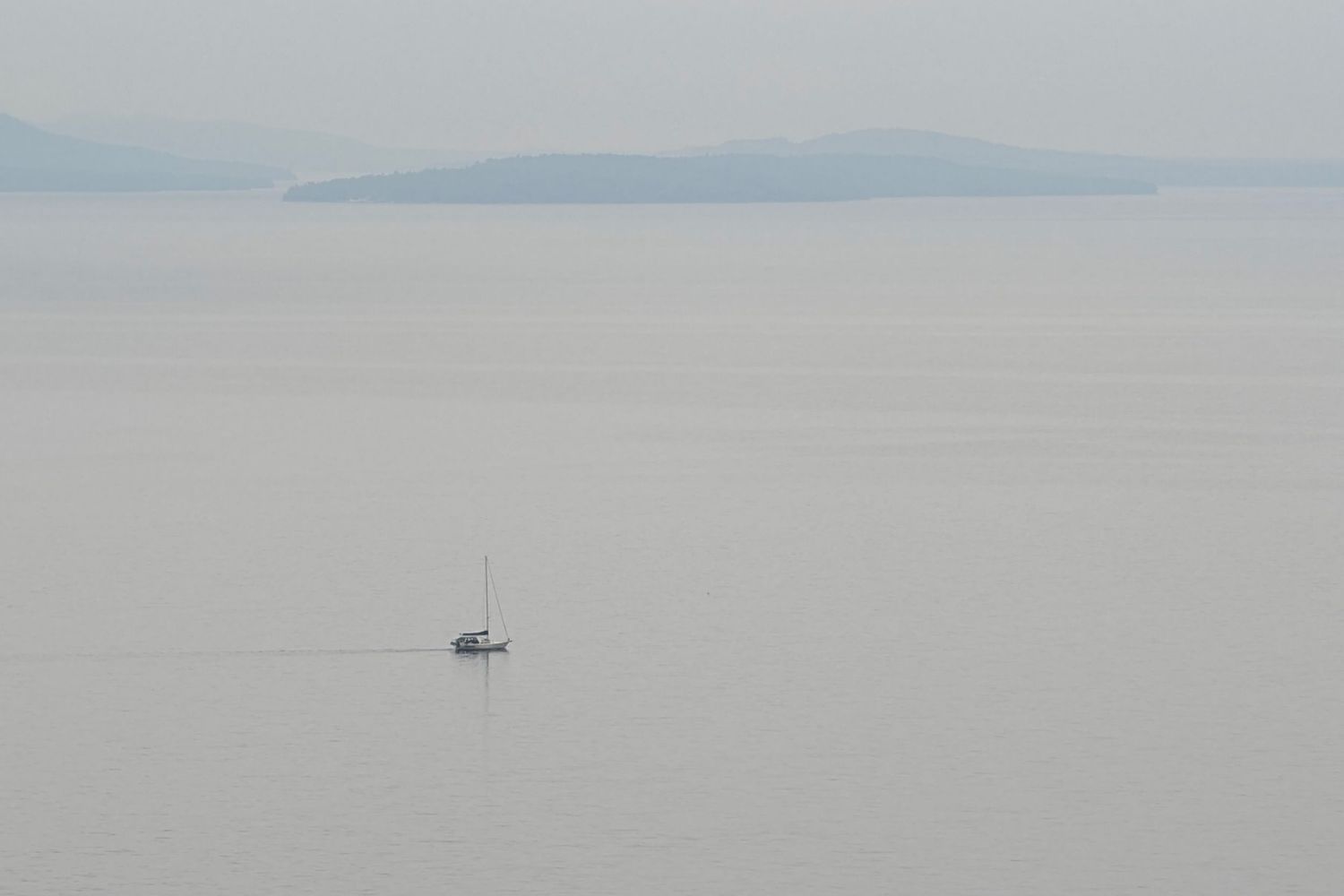 sailboat in lake with islands in the foggy background _ Manitoulin Island Ontario _ Yesterday's Focus by Mandy Wright