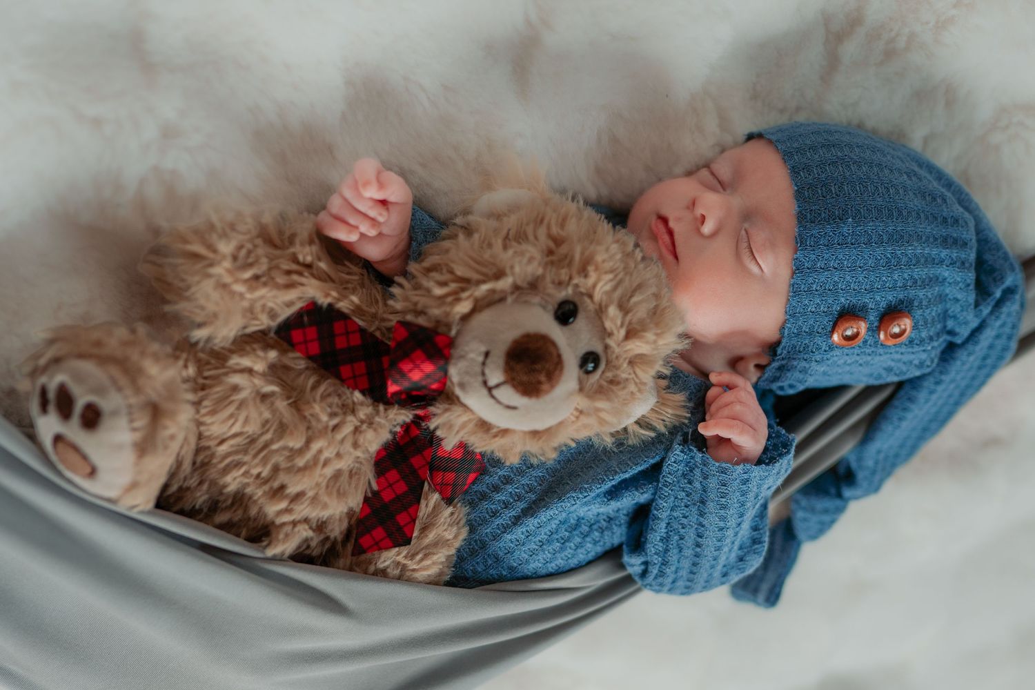 newborn in sling with teddy during newborn session in Madoc Ontario | Yesterday's Focus