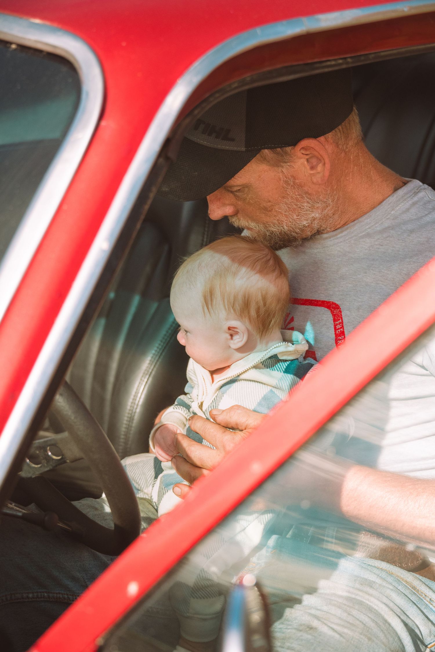 Grandpa and grandson in vintage car during family session in Tweed, Ontario | Yesterday's Focus