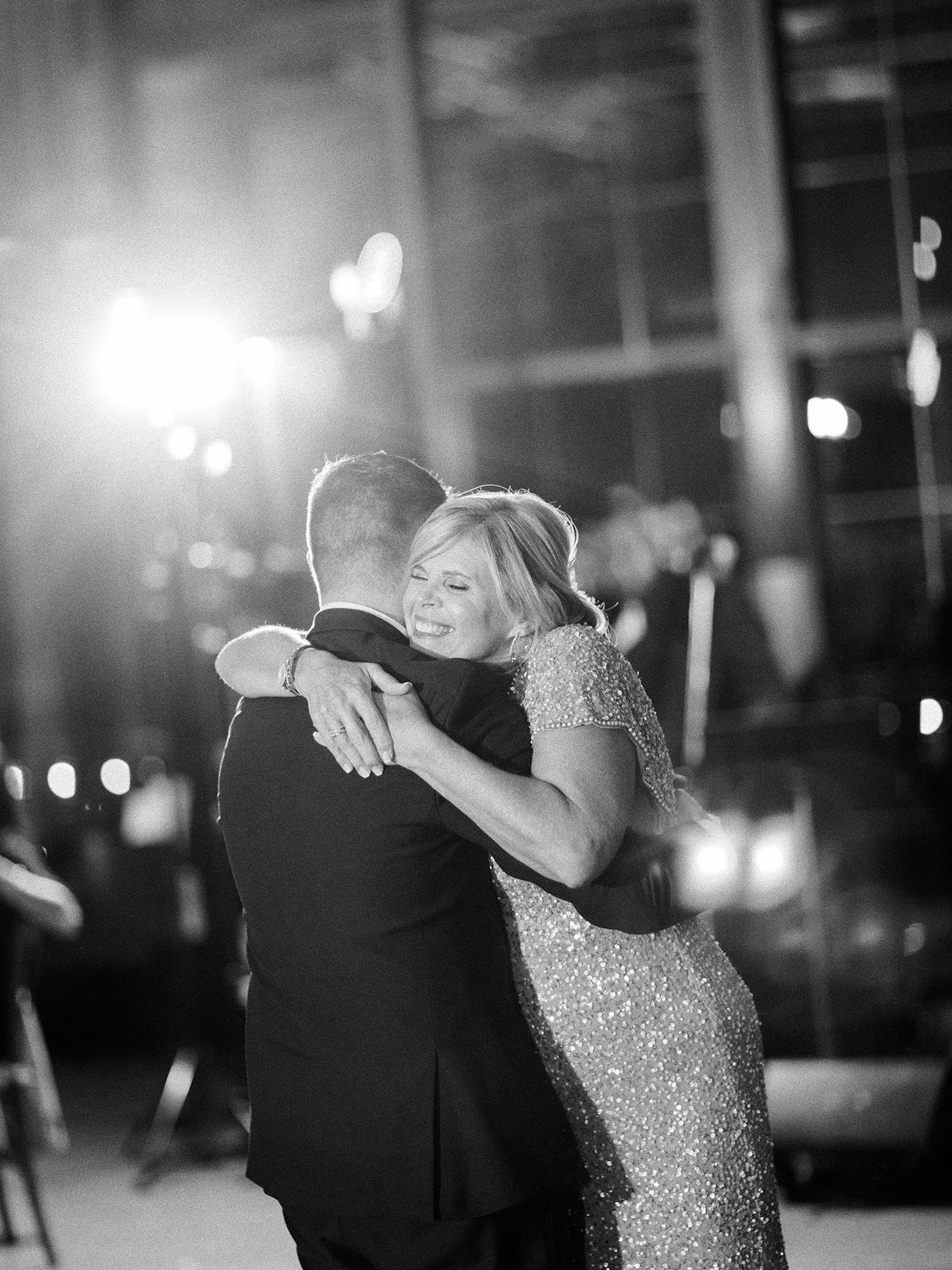 Couples sharing intimate dances during an evening reception with ambient lighting.