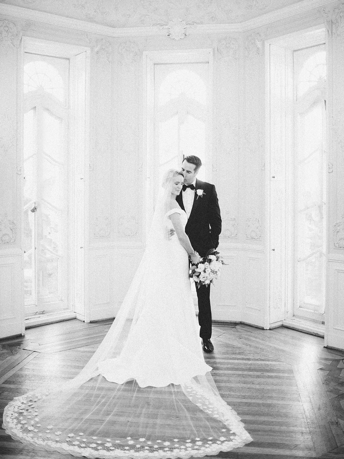 Classic black and white wedding portrait in an elegant room with tall windows. NYC wedding photographer.