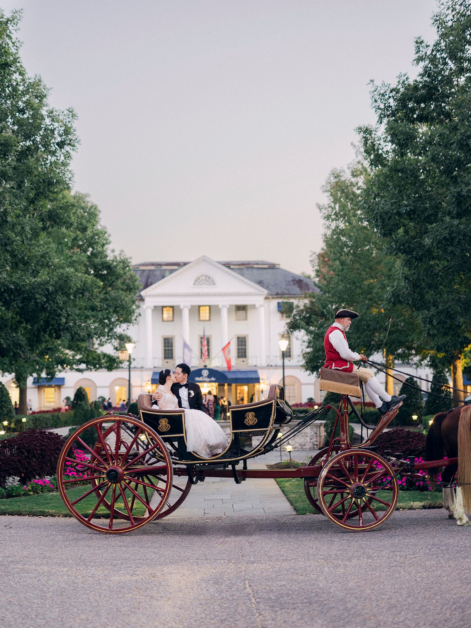 Historic cannons and artillery pieces displayed on grounds of a white colonial building.NYC wedding photographer.