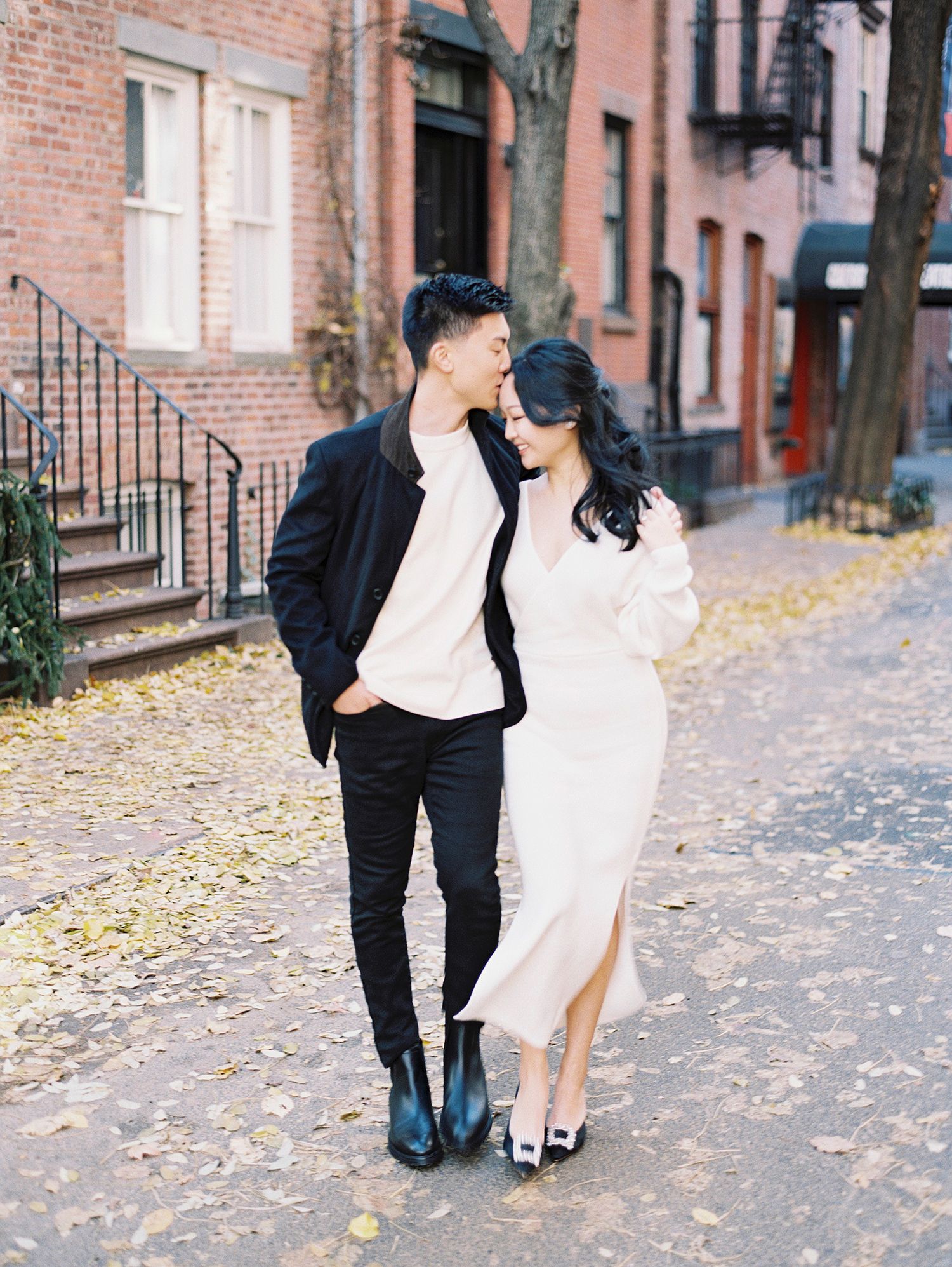 A stylish couple on a fall day in a historic brownstone neighborhood.