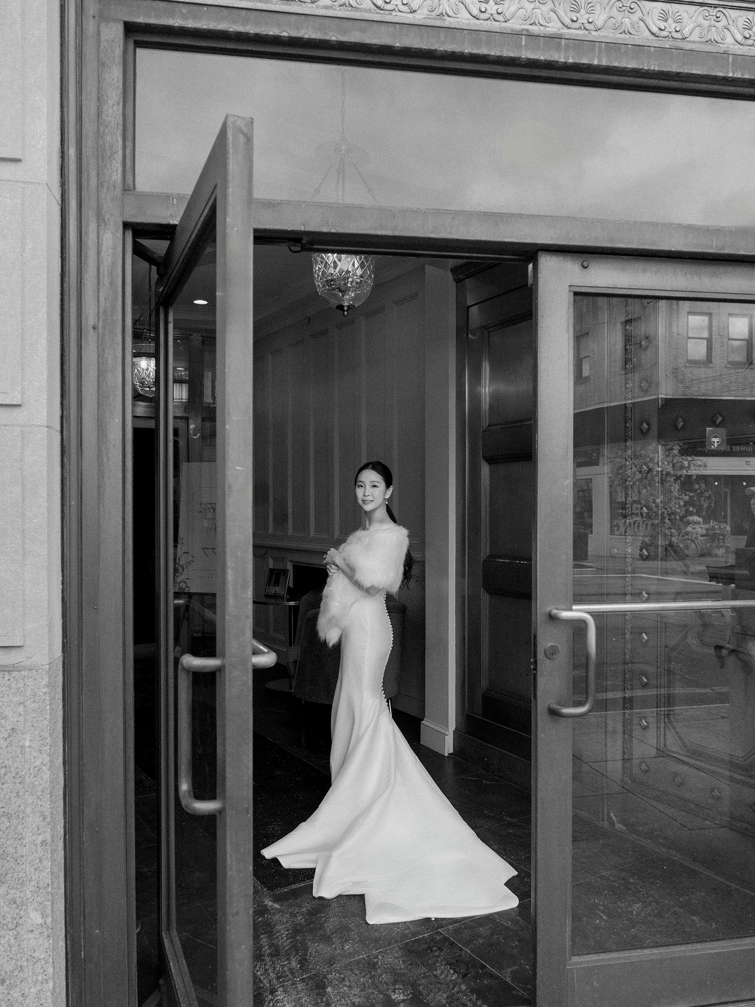 Wedding dress displays in storefront windows create an elegant retail scene. NJ Wedding photographer.