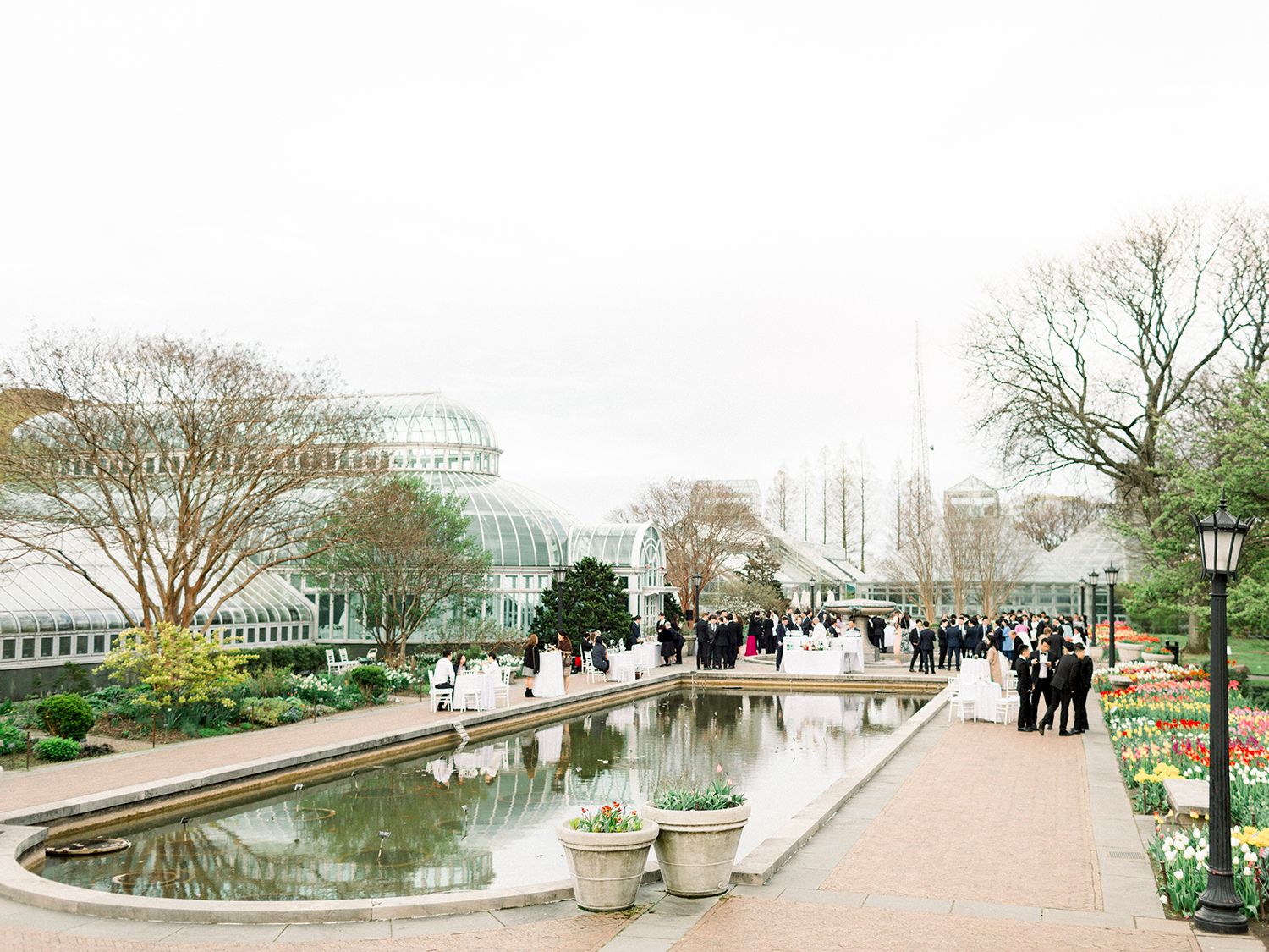 Panoramic view of a waterfront venue with classic architecture and landscaping.