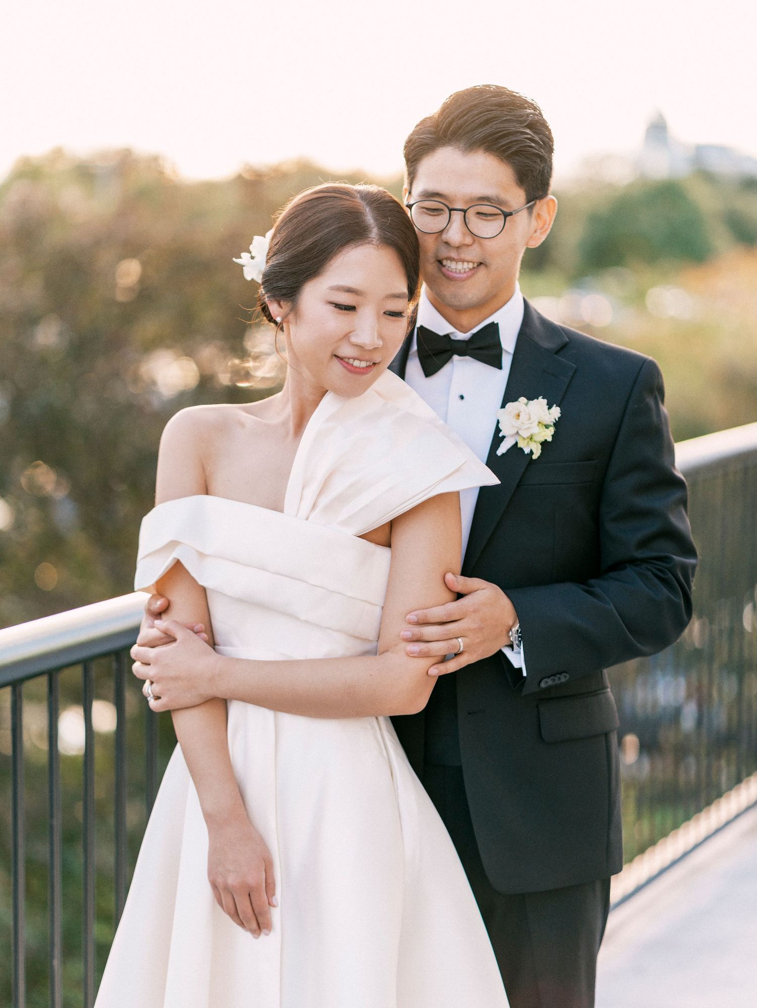 Romantic sunset portraits of a couple in wedding attire on an outdoor terrace.