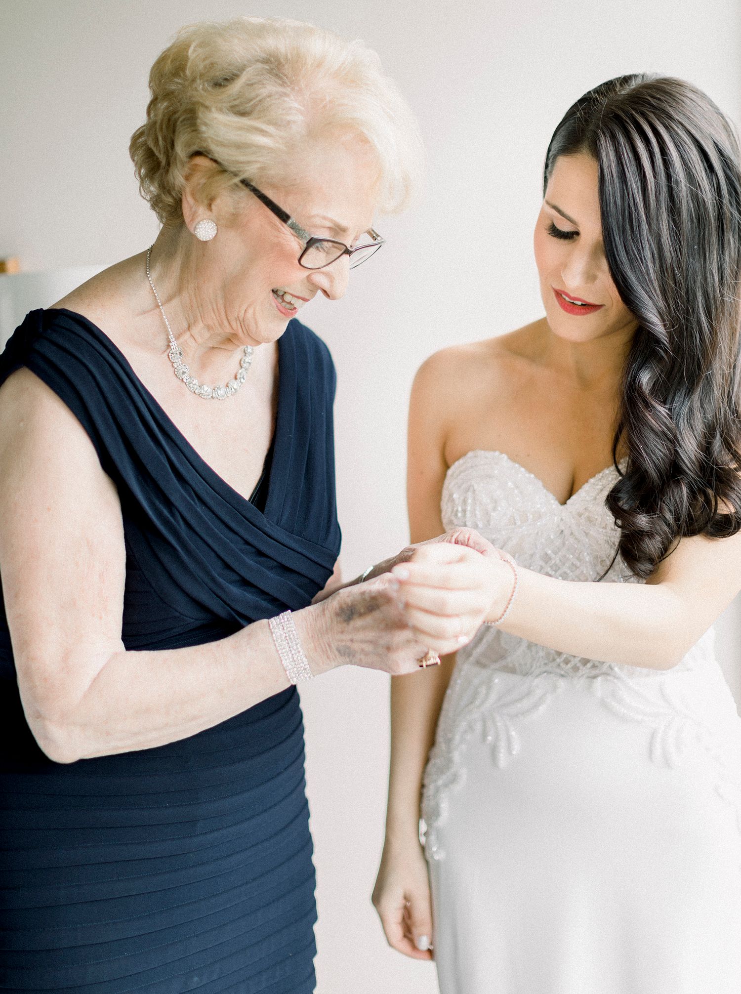 Intimate moments shared between two people in formal attire with navy blue and white dresses.