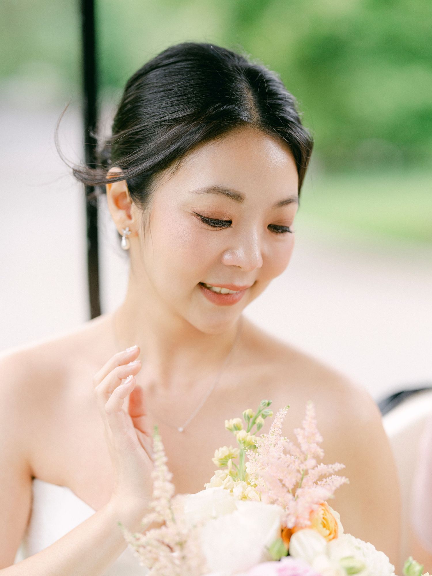 Delicate pink and peach floral bouquet arrangement in soft natural lighting.