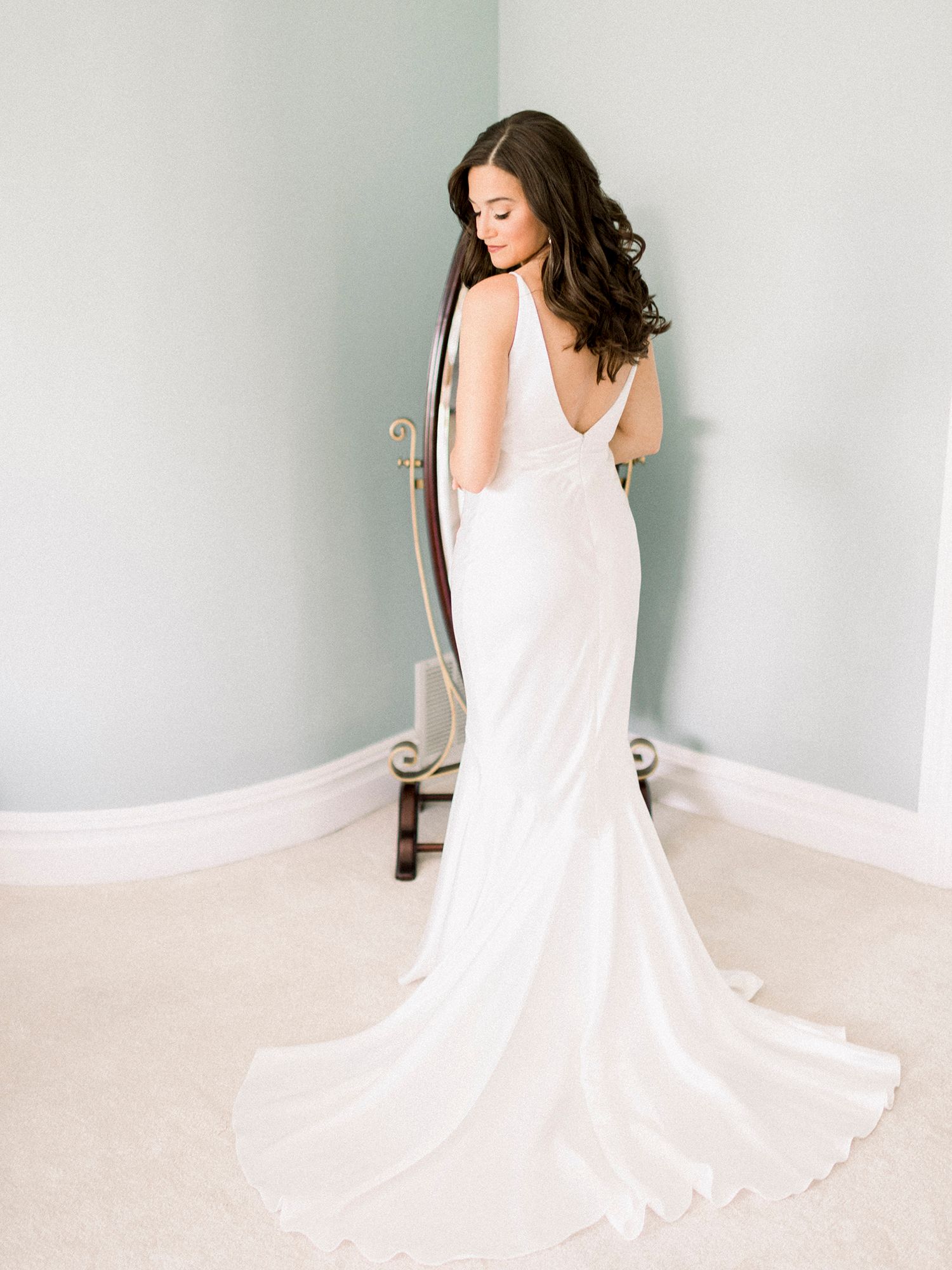 Woman in flowing white dress twirling to show the movement of the fabric.