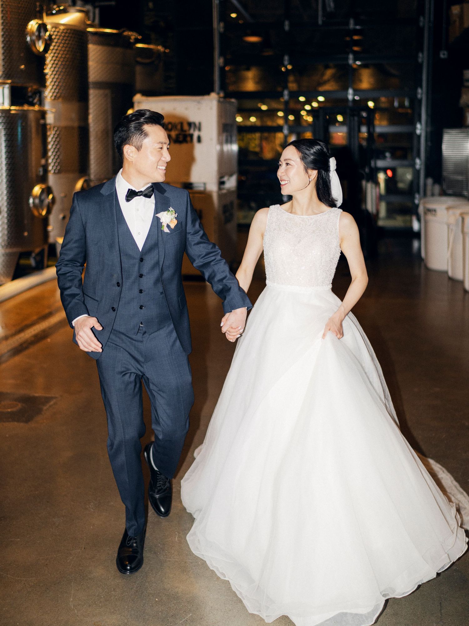 A joyful wedding moment captured in an industrial-chic venue with warm lighting.