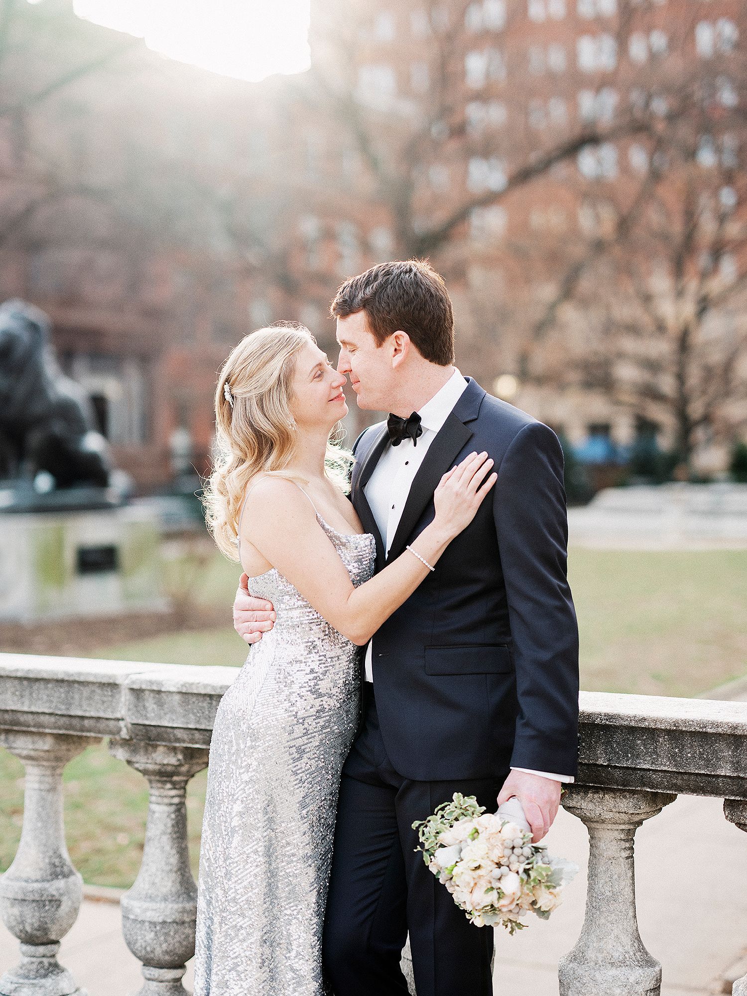 Romantic wedding couple embracing on stone steps during an outdoor winter photoshoot. NYC wedding photographer.