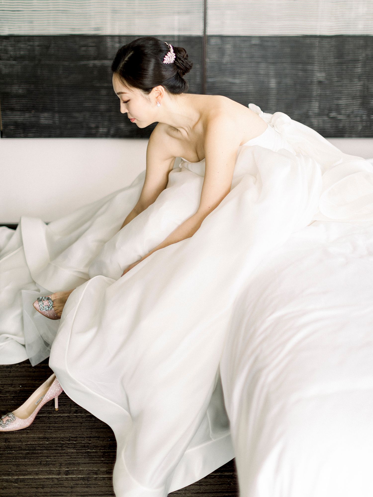 Flowing white fabric creates elegant movement against dark background in artistic photography.