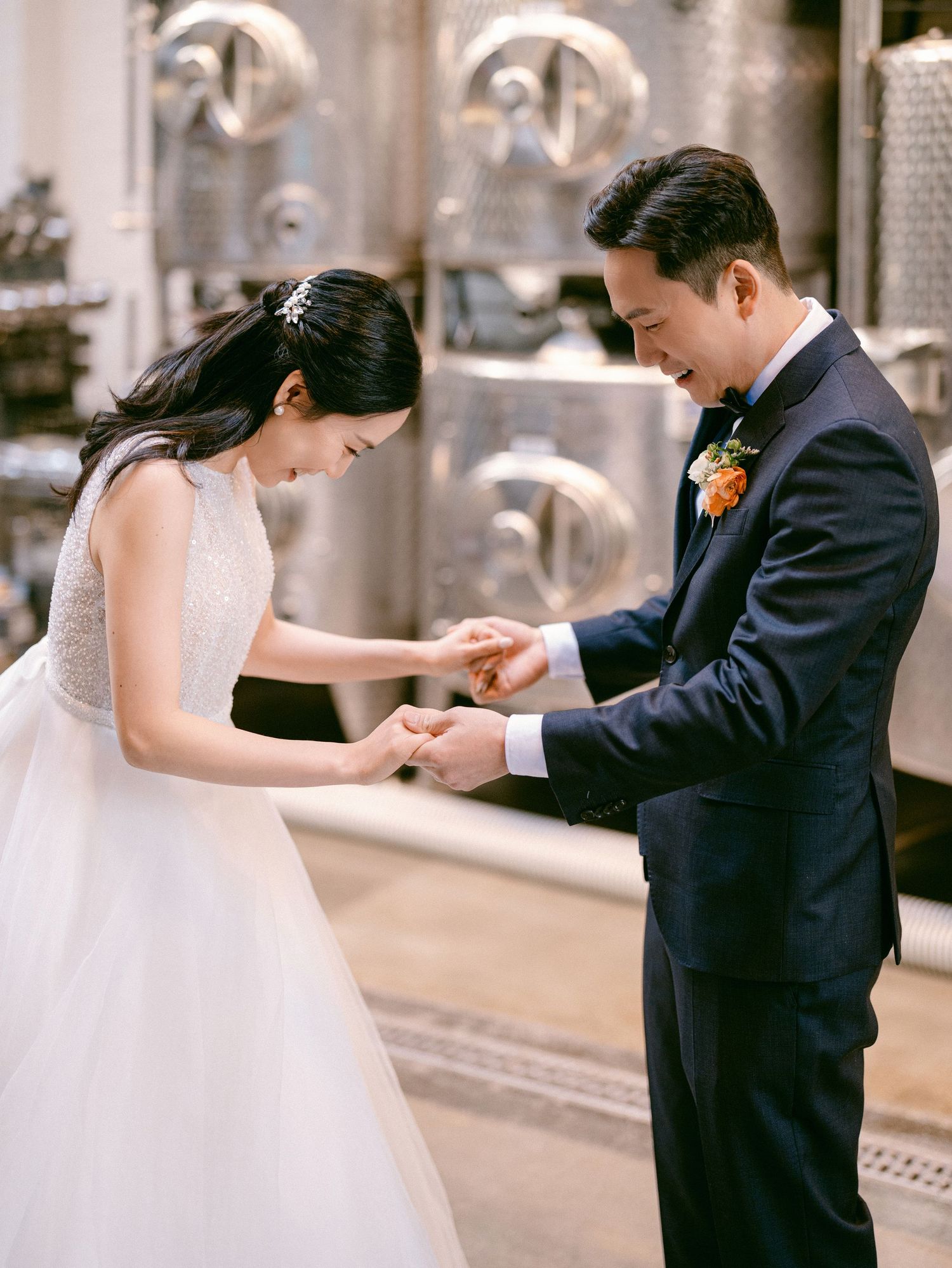 Wedding couple sharing an intimate moment while dancing in formal attire.