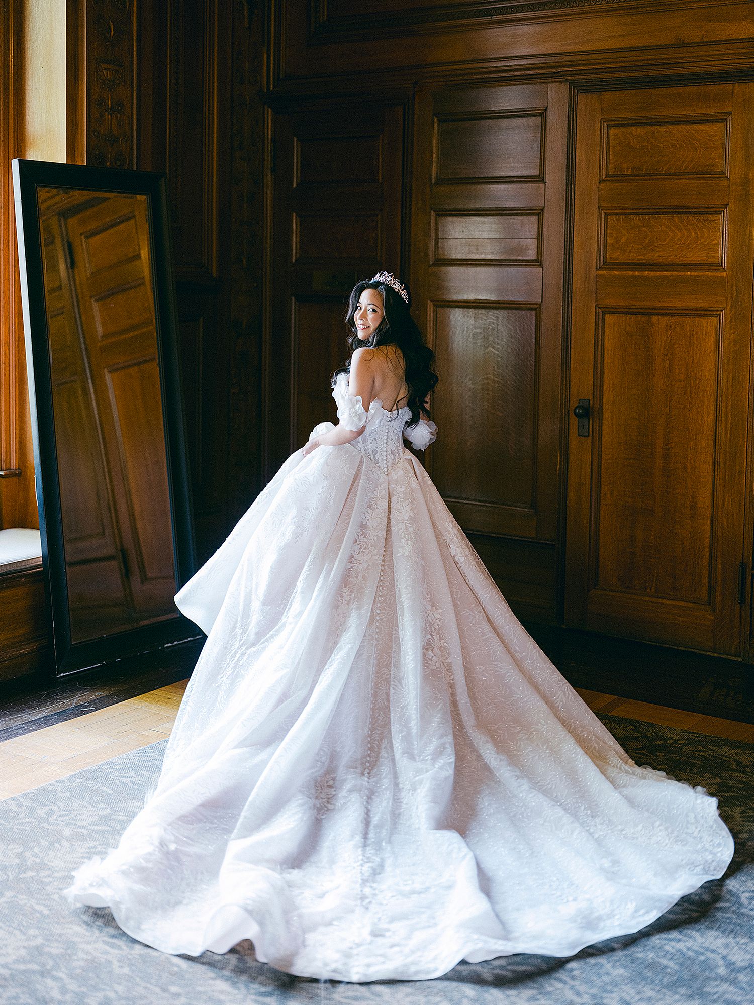 Wedding gown with dramatic train photographed from different angles on hardwood floor. NYC Wedding Photographer