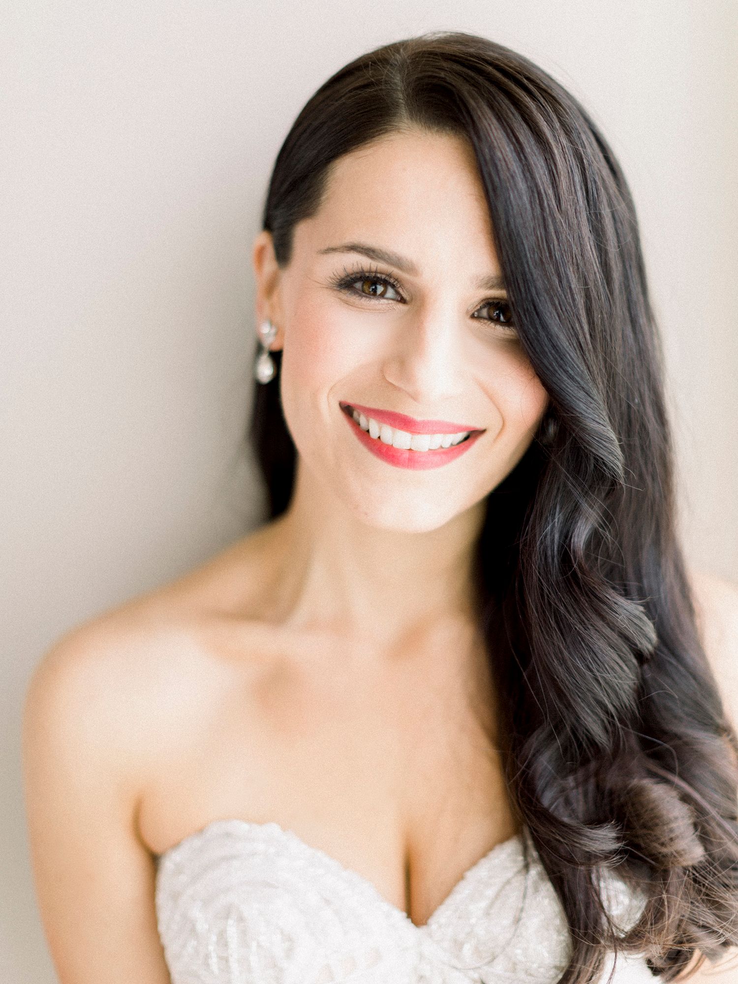 Close-up bridal portraits showing joyful expressions in a white lace gown.