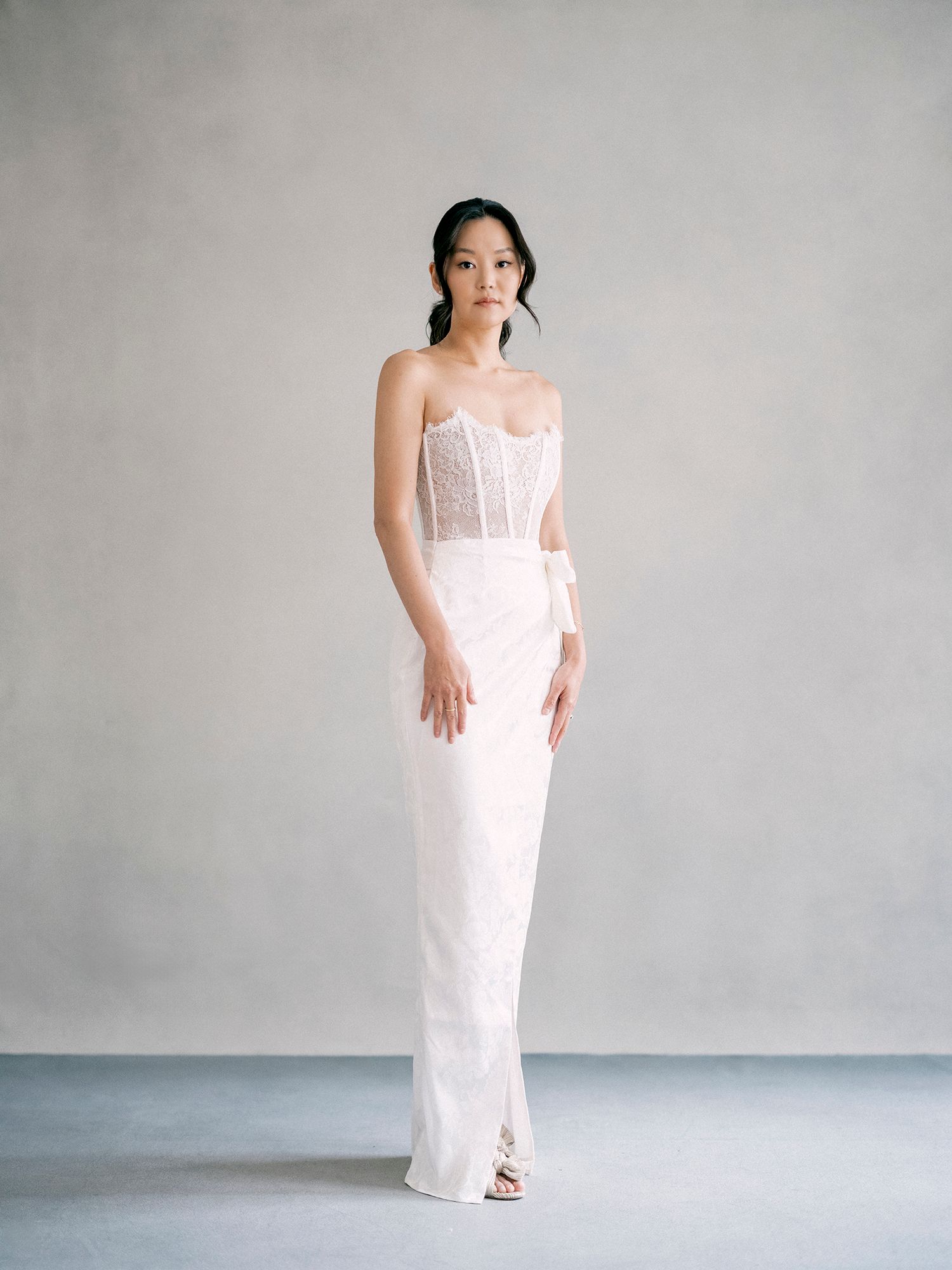A sequence of minimalist photos showing someone in a flowing white dress against a neutral gray background.